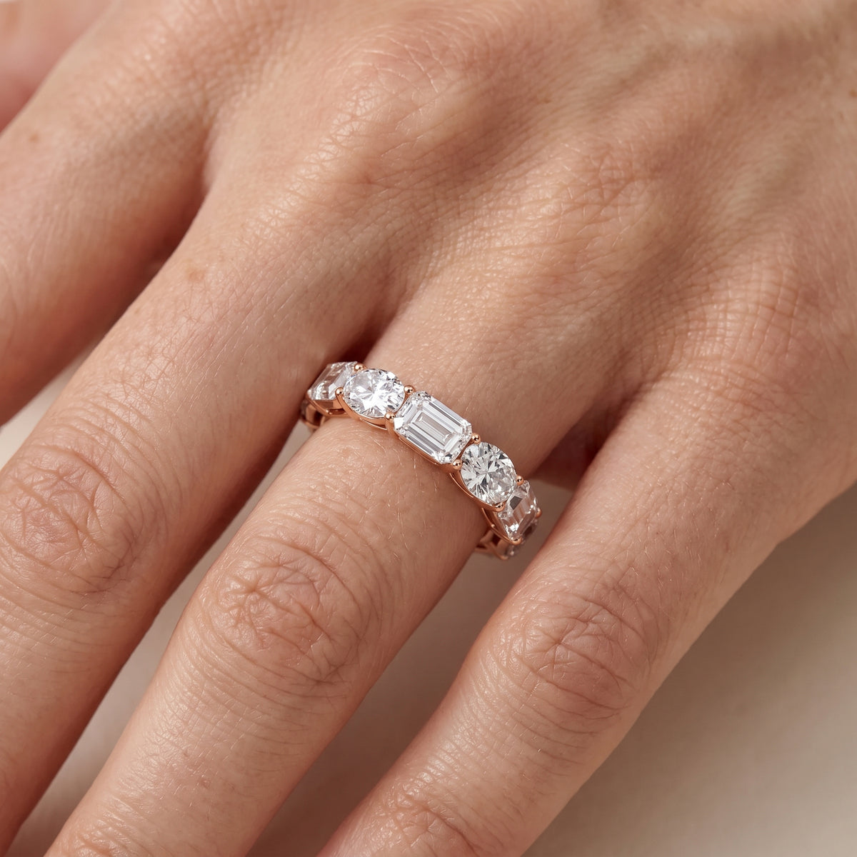 Avery Shared Prong Emerald & Oval Diamond Eternity Band in Rose Gold - lifestyle.jpg