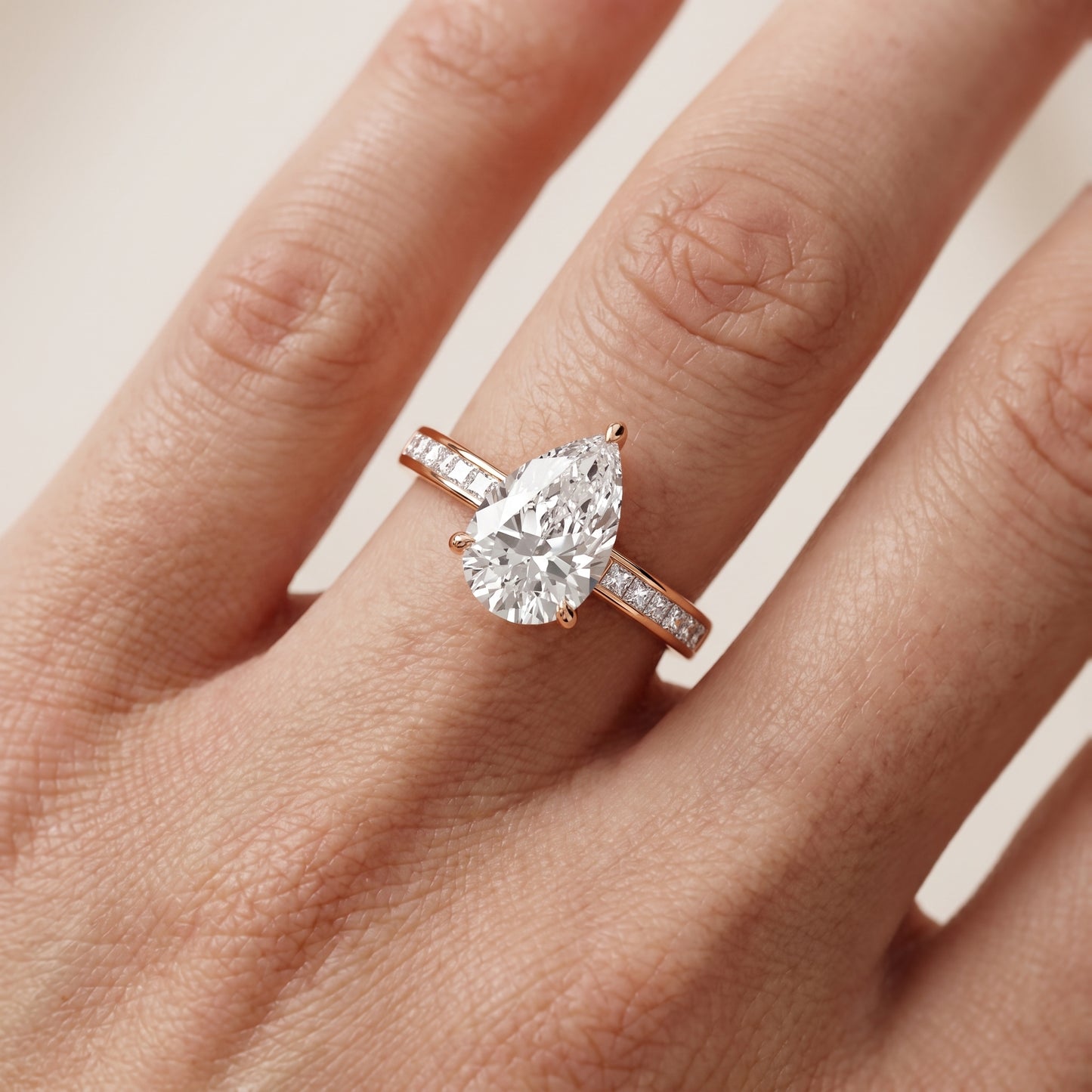Maren Sidestone Channel Set Pear Diamond Engagement Ring in Rose Gold - lifestyle.jpg