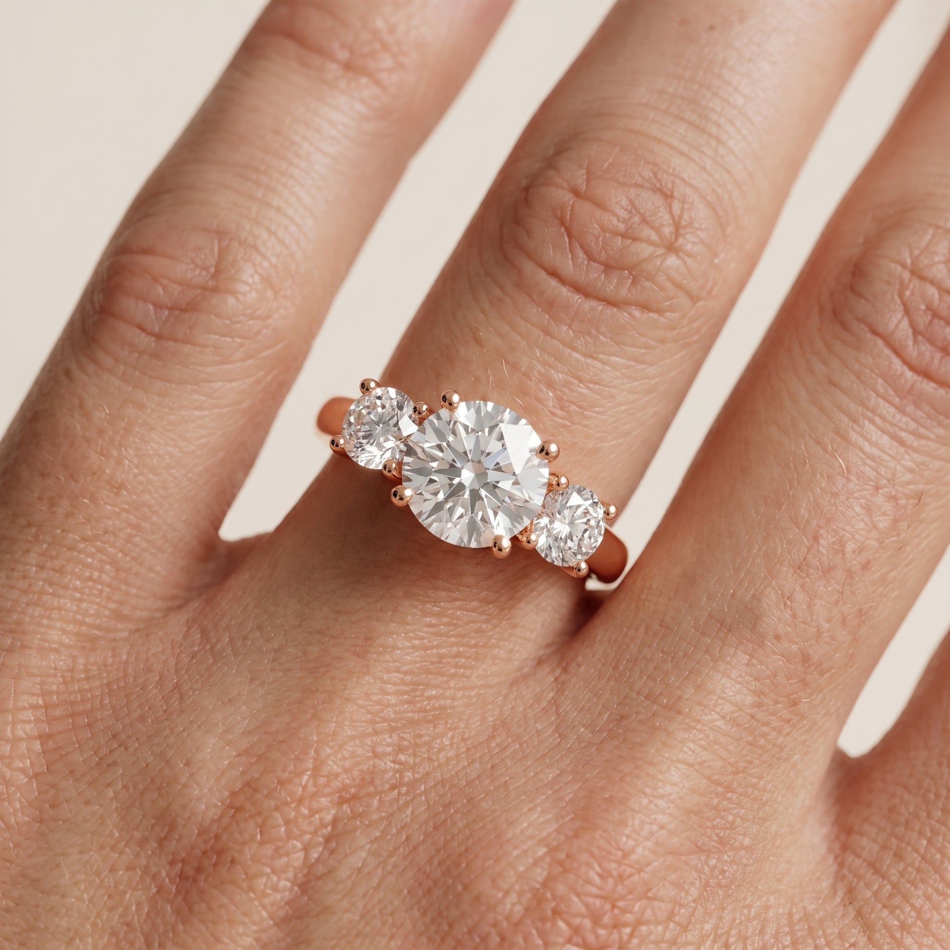Callie Three-Stone Trellis Round Diamond Engagement Ring in Rose Gold - lifestyle.jpg