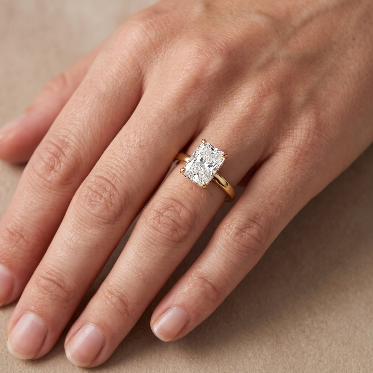 Lara Hidden Halo Radiant Diamond Engagement Ring in Yellow Gold - lifestyle.jpg