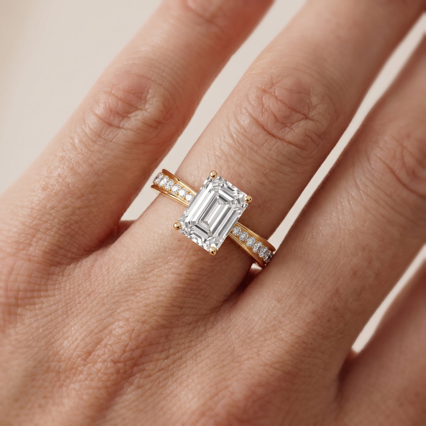 Rhea Sidestone Pavé Emerald Diamond Engagement Ring in Yellow Gold - lifestyle.jpg