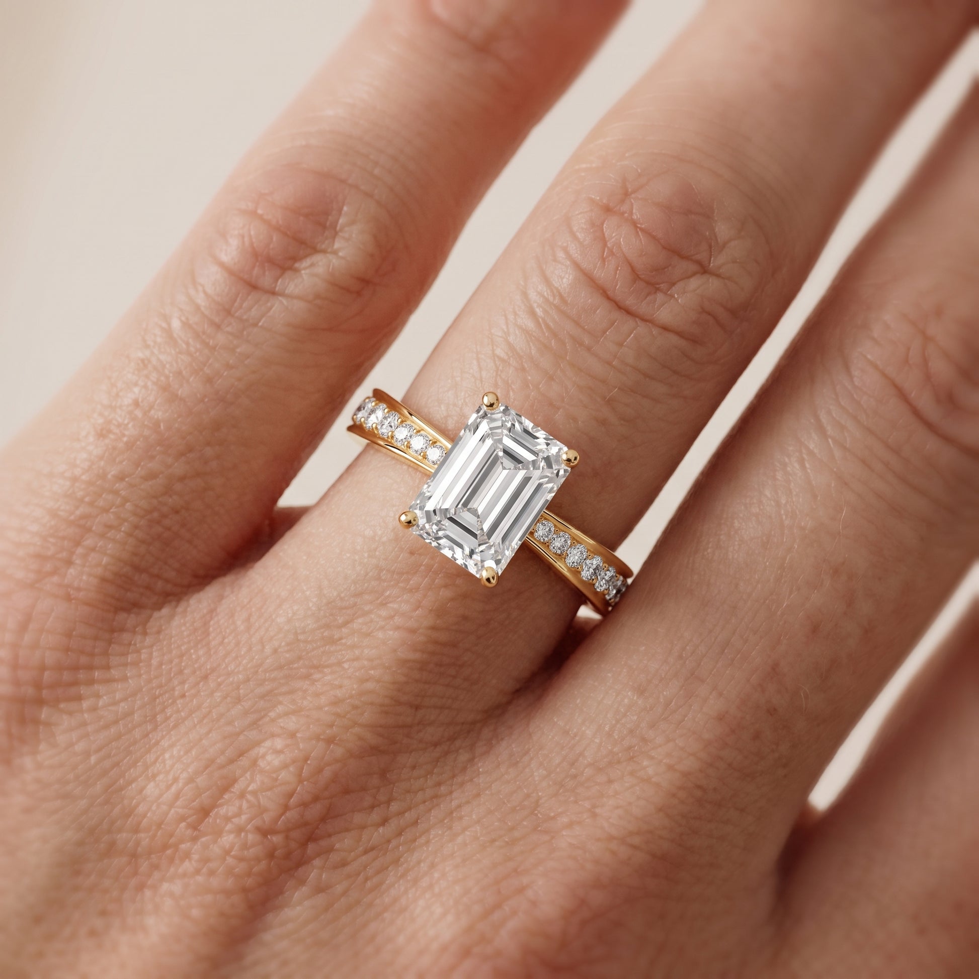 Rhea Sidestone Pavé Emerald Diamond Engagement Ring in Yellow Gold - lifestyle.jpg