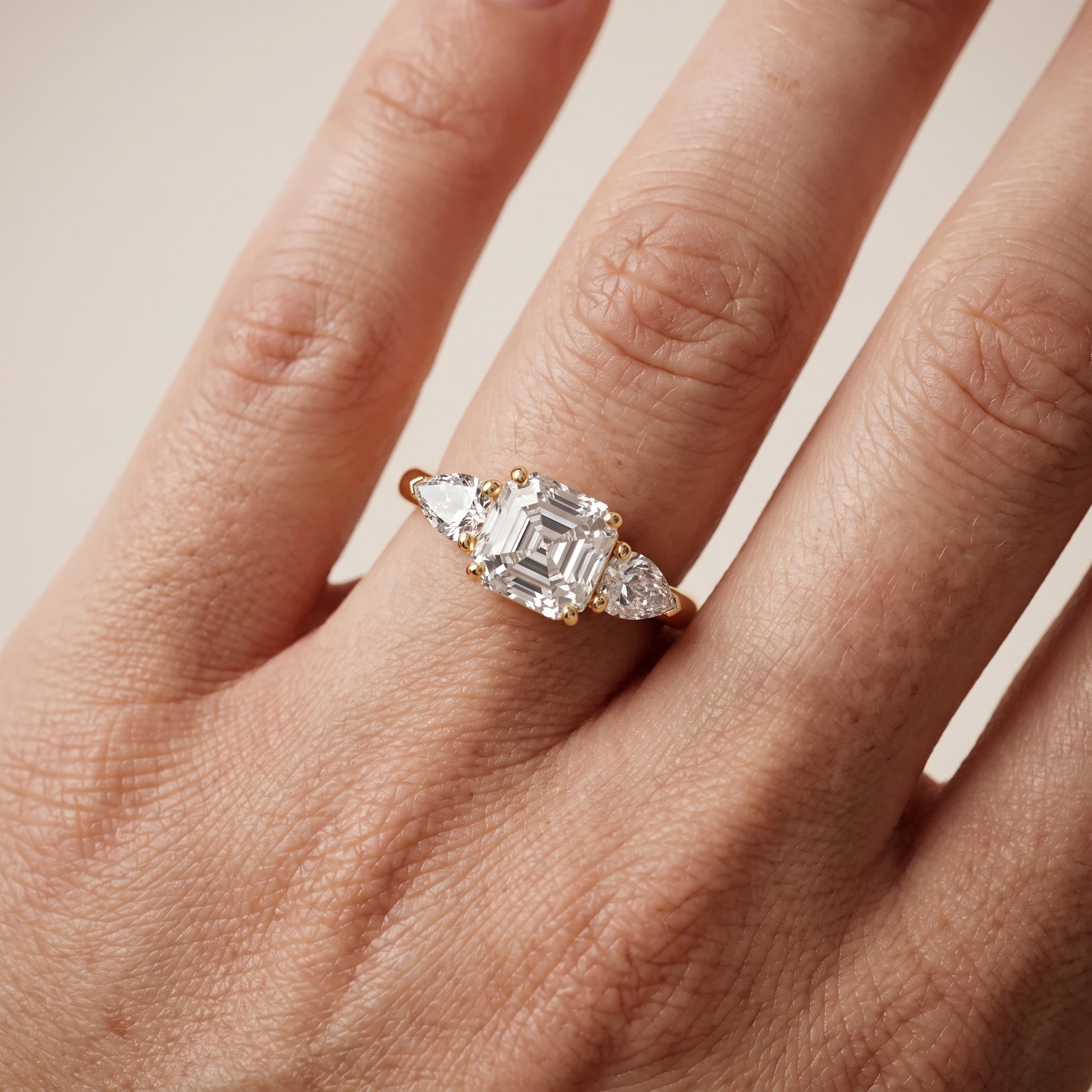 Mirabel Three-Stone Asscher Diamond Engagement Ring in Yellow Gold - lifestyle.jpg