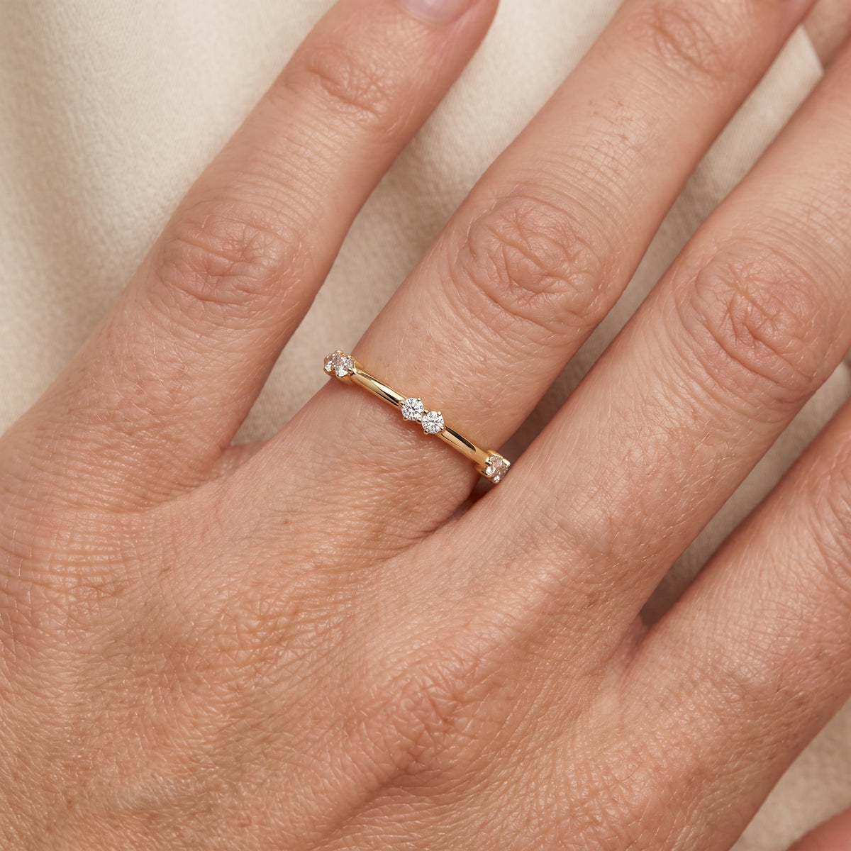 Penelope Claw Prong Round Diamond Wedding Band in Yellow Gold - lifestyle.jpg