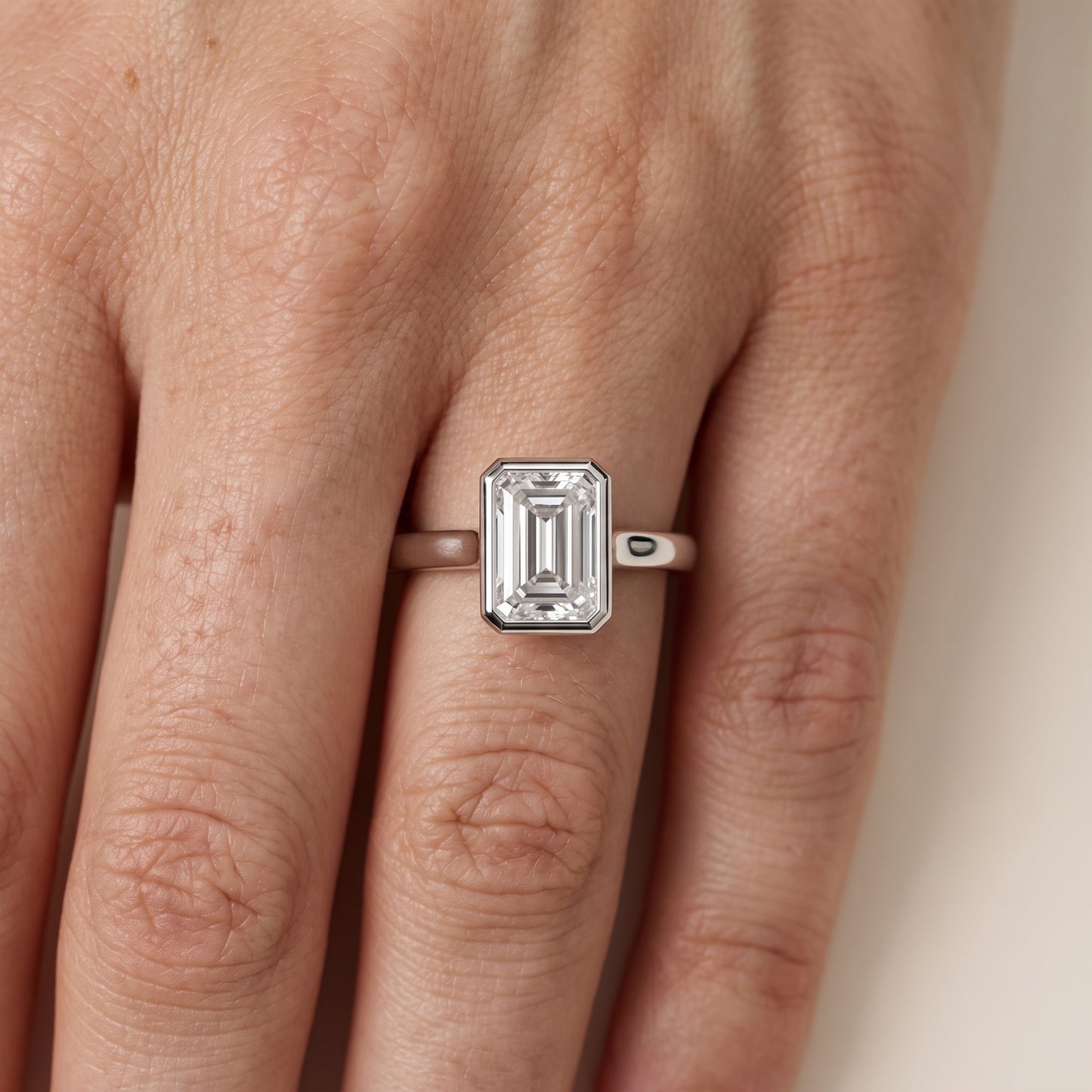 Jolie Bezel Solitaire Emerald Diamond Engagement Ring in Silver - lifestyle.jpg