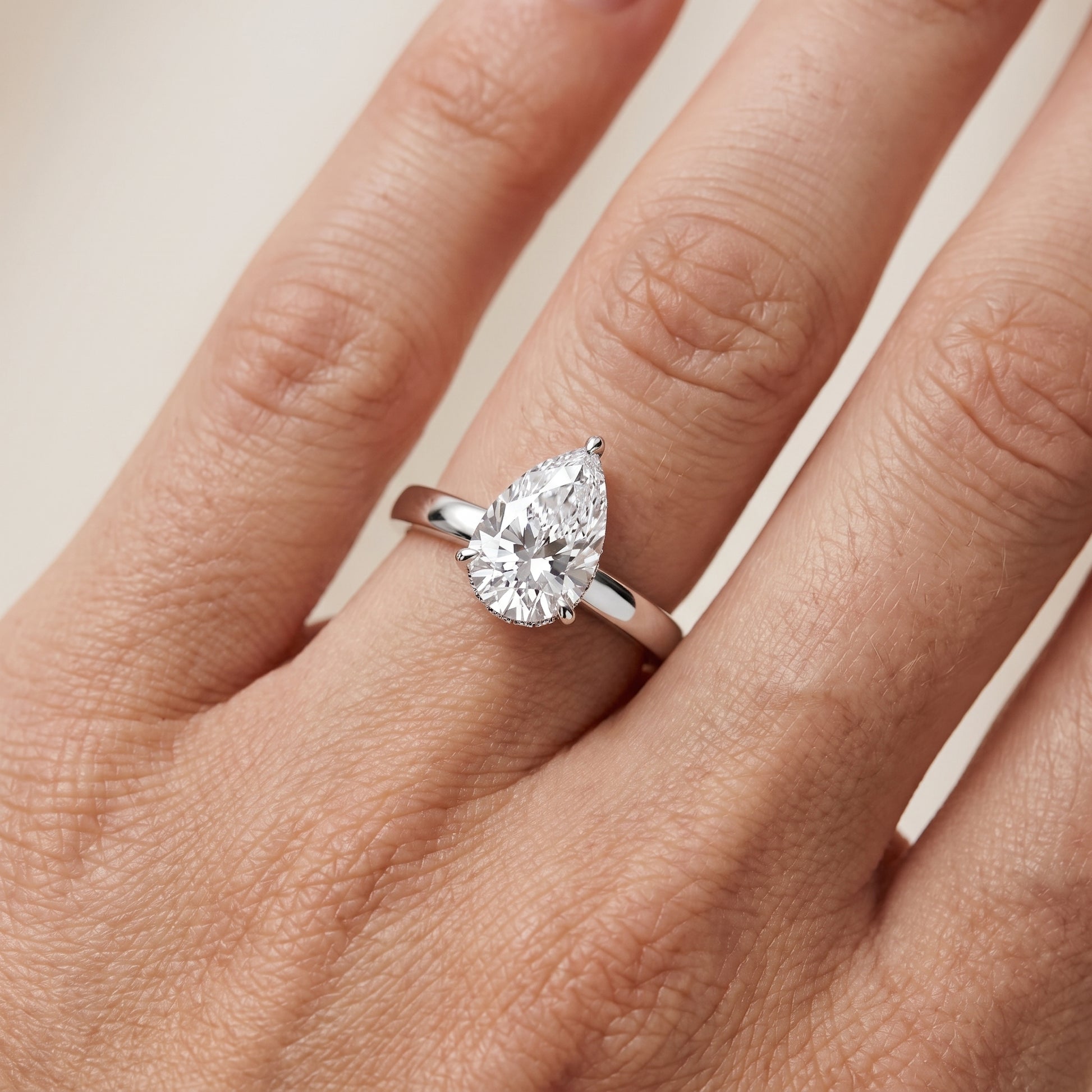 Lara Hidden Halo Pear Diamond Engagement Ring in Platinum - lifestyle.jpg