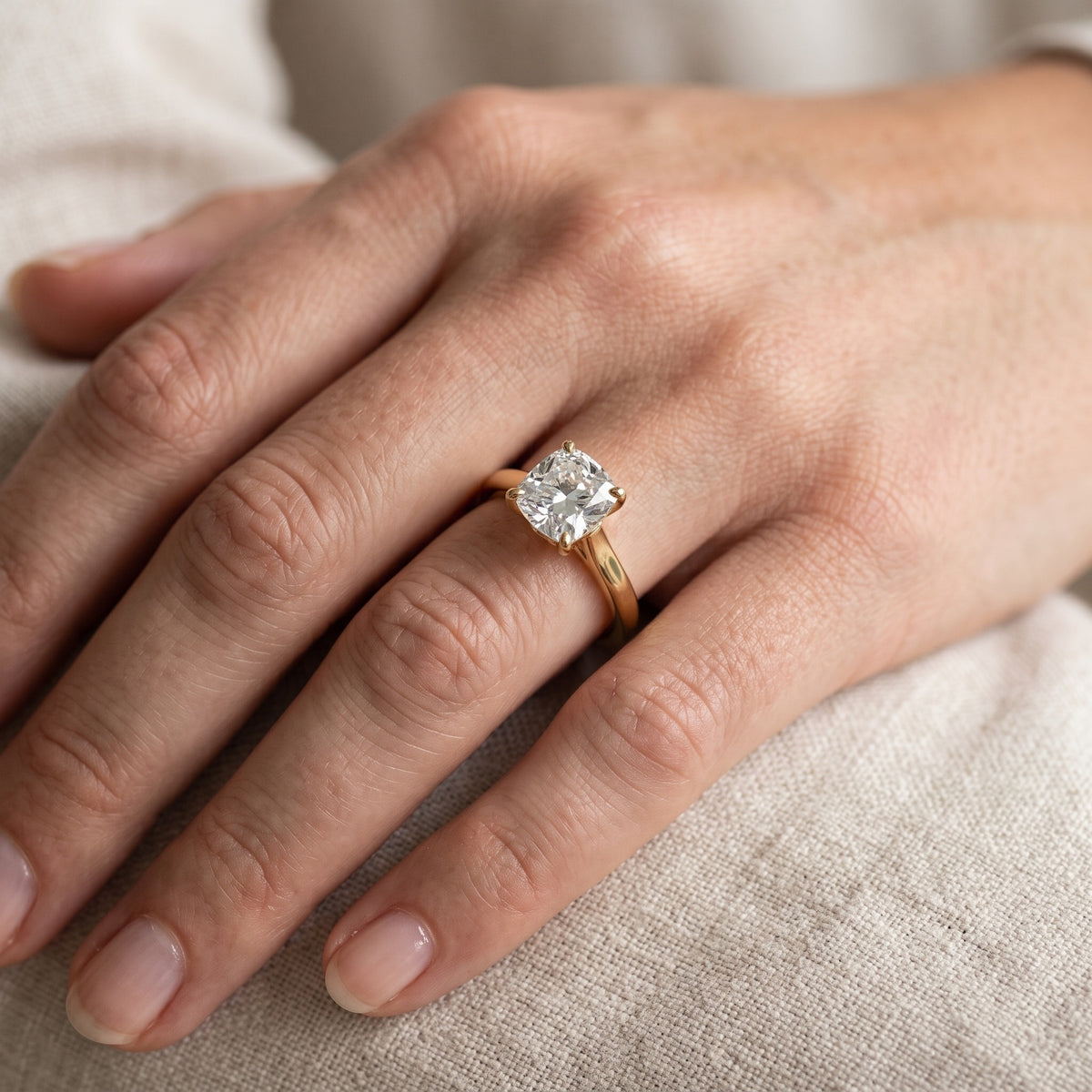 Emeline Solitaire Cathedral Cushion Diamond Engagement Ring in Yellow Gold - lifestyle.jpg