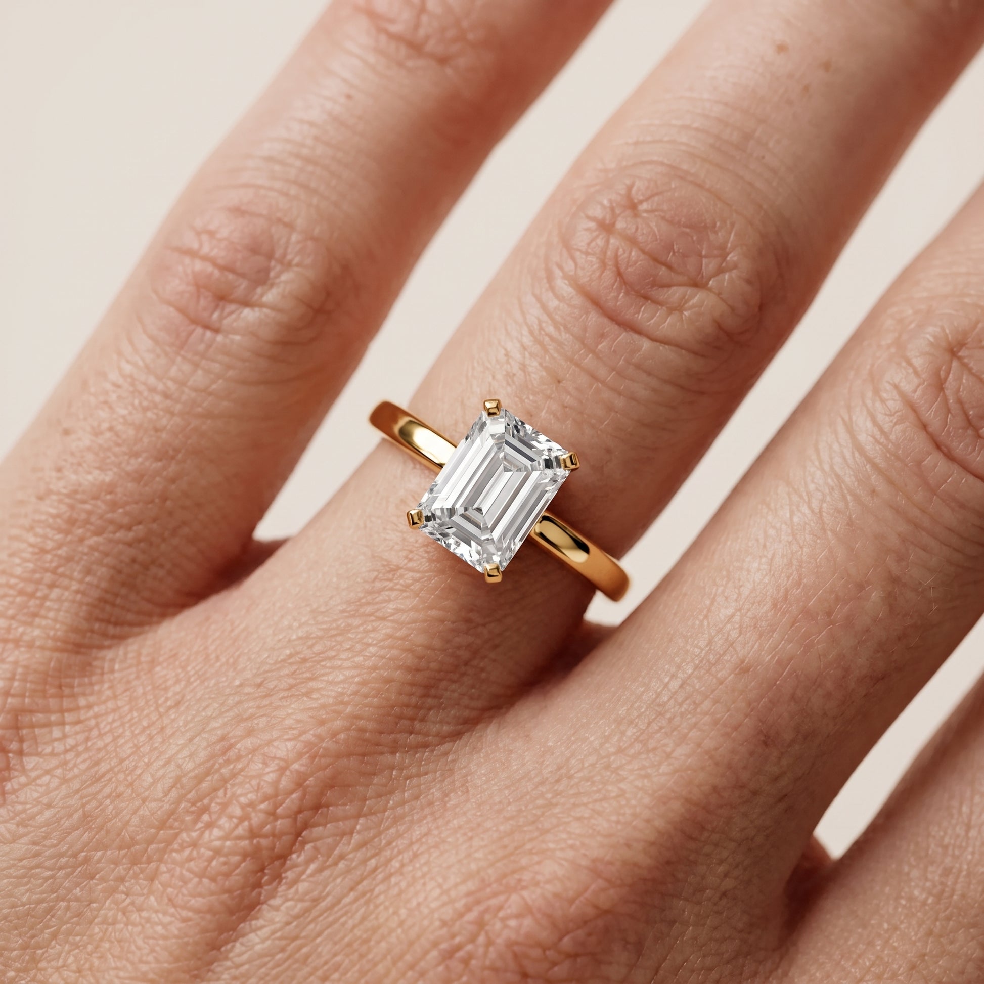 Liana Solitaire Claw Prong Emerald Diamond Engagement Ring in Yellow Gold - lifestyle.jpg
