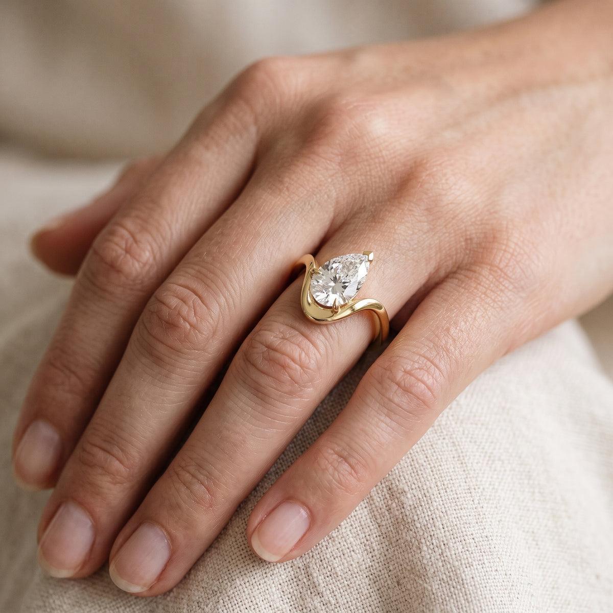 Empire Solitaire Bypass Pear Diamond Engagement Ring in Yellow Gold - lifestyle.jpg