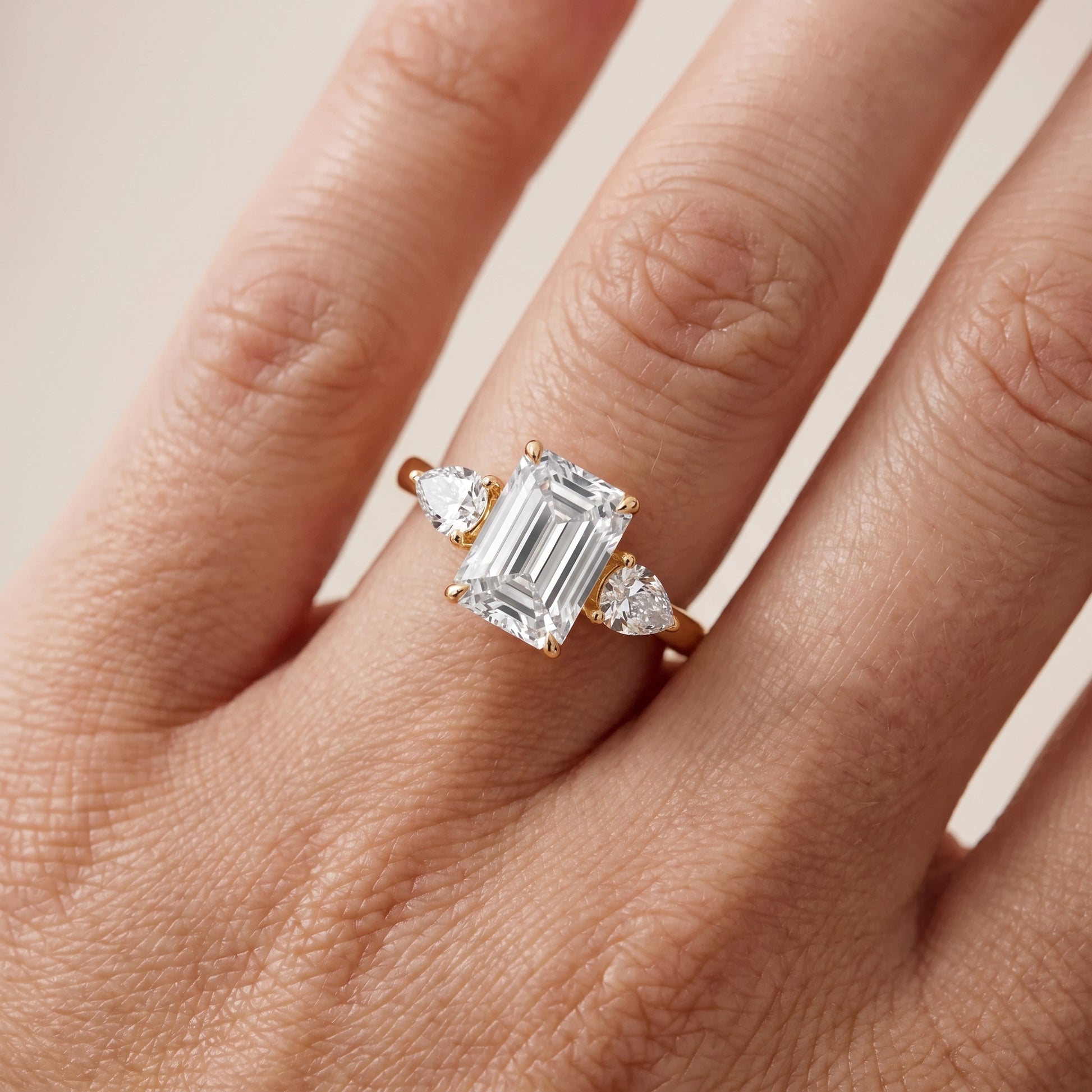 Phoebe Three-Stone Emerald Diamond Ring in Yellow Gold - lifestyle.jpg
