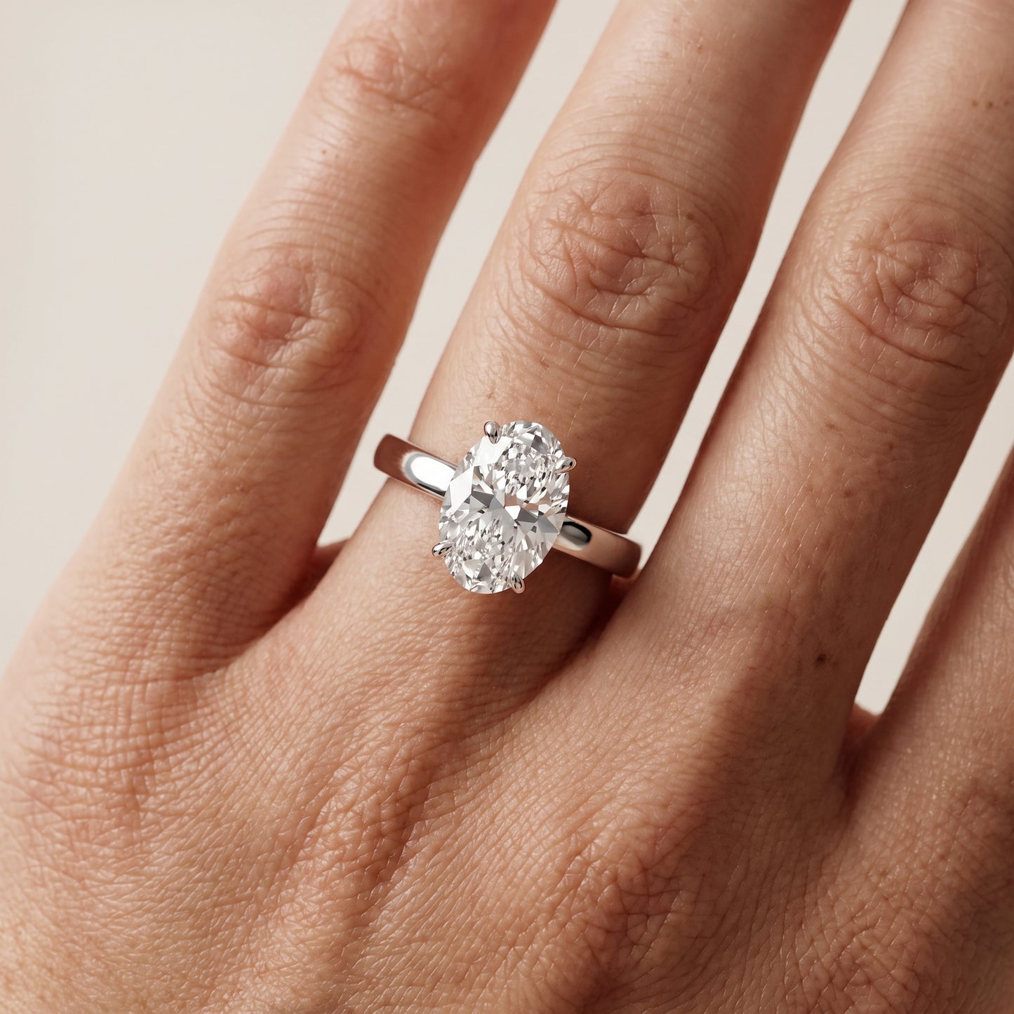 Lara Hidden Halo Oval Diamond Engagement Ring in Platinum - lifestyle.jpg