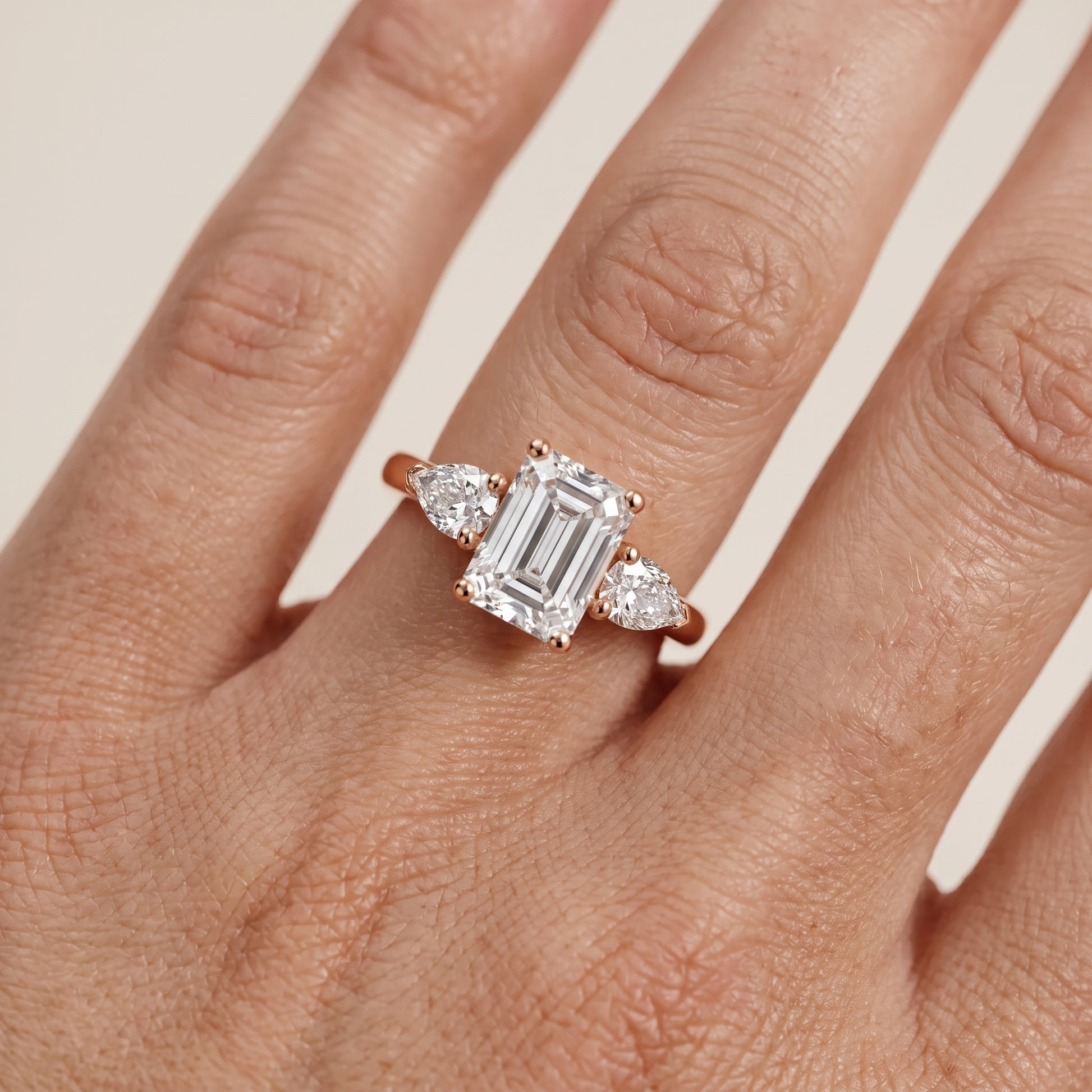 Mirabel Three-Stone Emerald Diamond Engagement Ring in Rose Gold - lifestyle.jpg