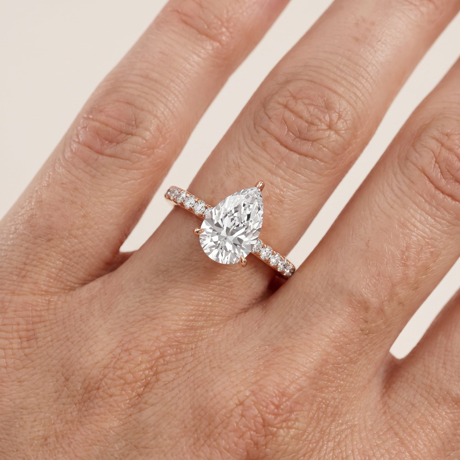 Thea Hidden Halo Pavé Pear Diamond Engagement Ring in Rose Gold - lifestyle.jpg