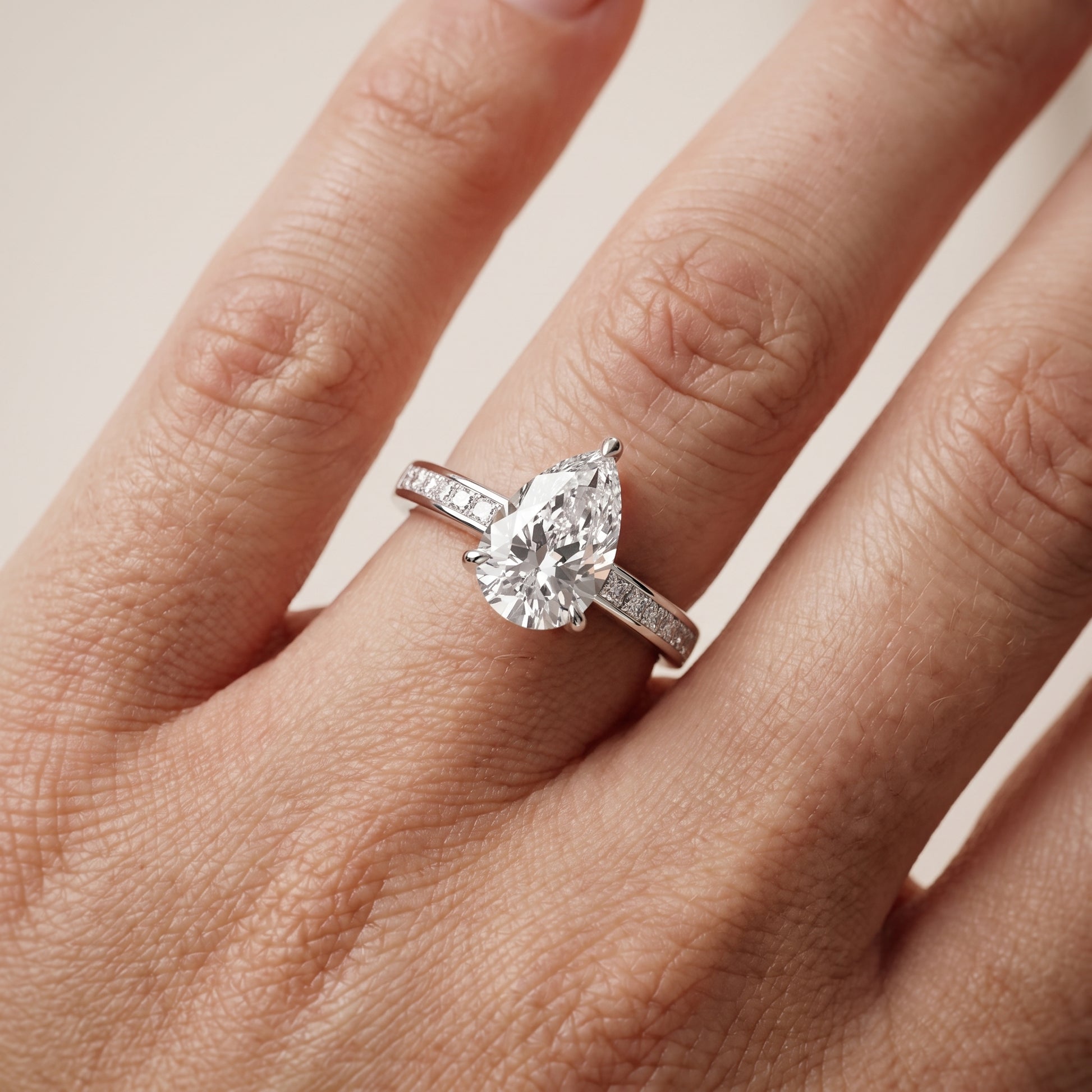 Maren Sidestone Channel Set Pear Diamond Engagement Ring in Silver - lifestyle.jpg