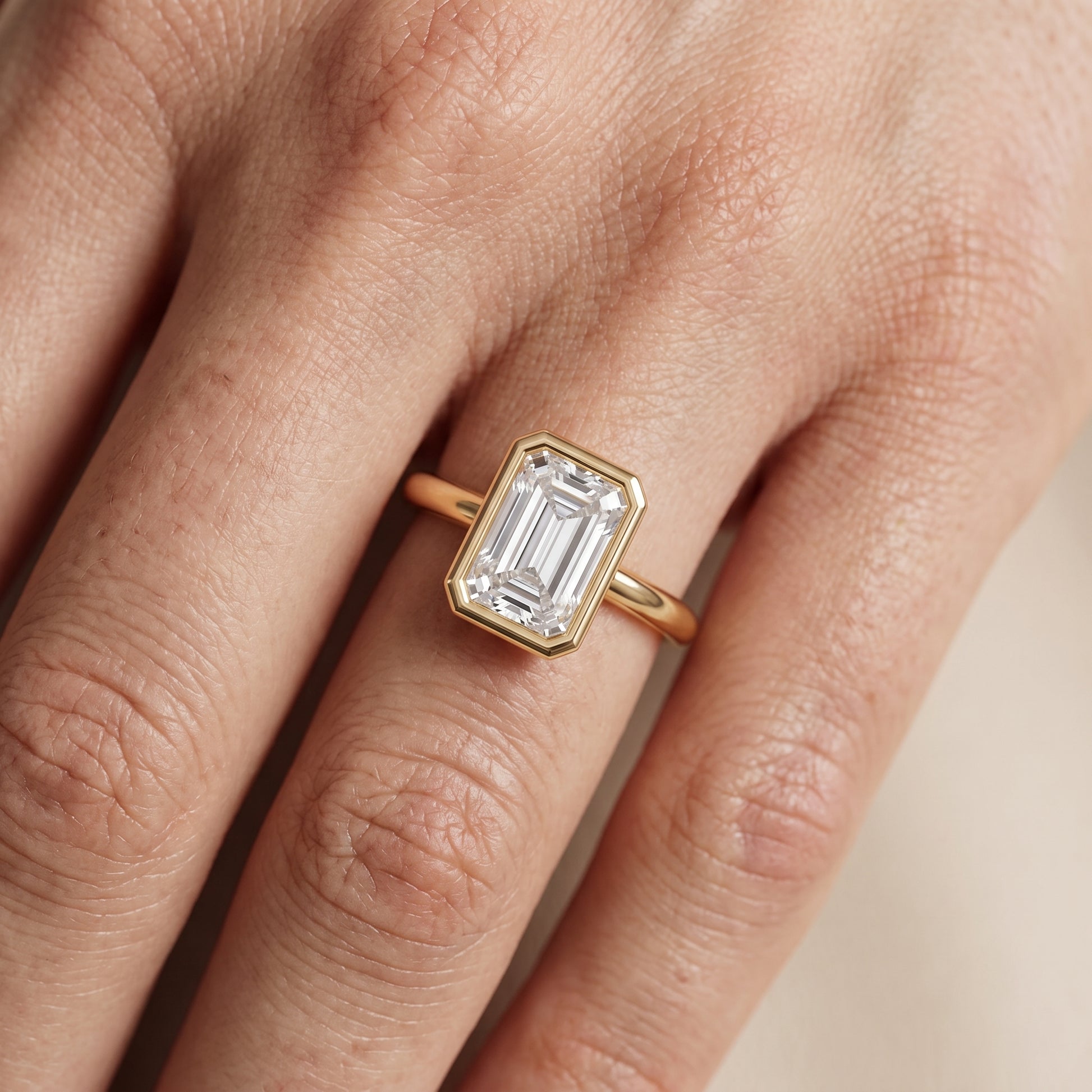 Maeve Bezel Solitaire Emerald Diamond Ring in Yellow Gold - lifestyle.jpg