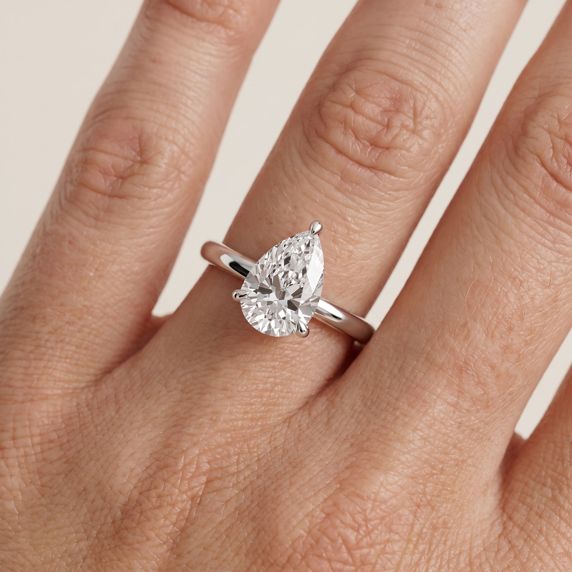 Nella Petite Solitaire Pear Diamond Engagement Ring in Silver - lifestyle.jpg