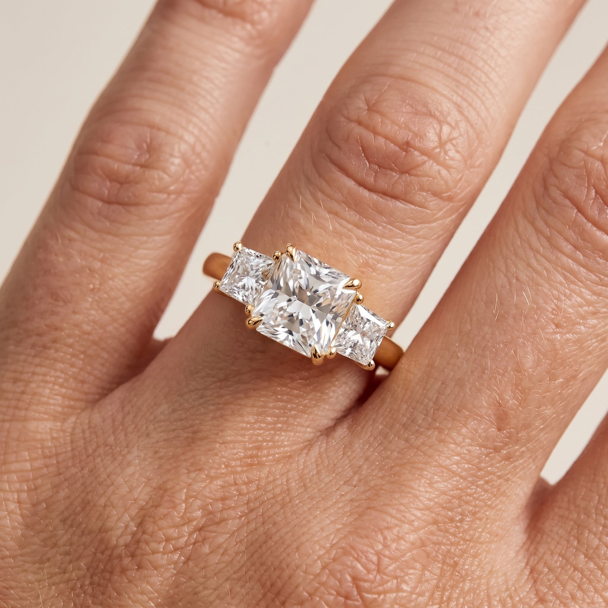 Sienna Three-Stone Radiant Diamond Ring in Yellow Gold - lifestyle.jpg