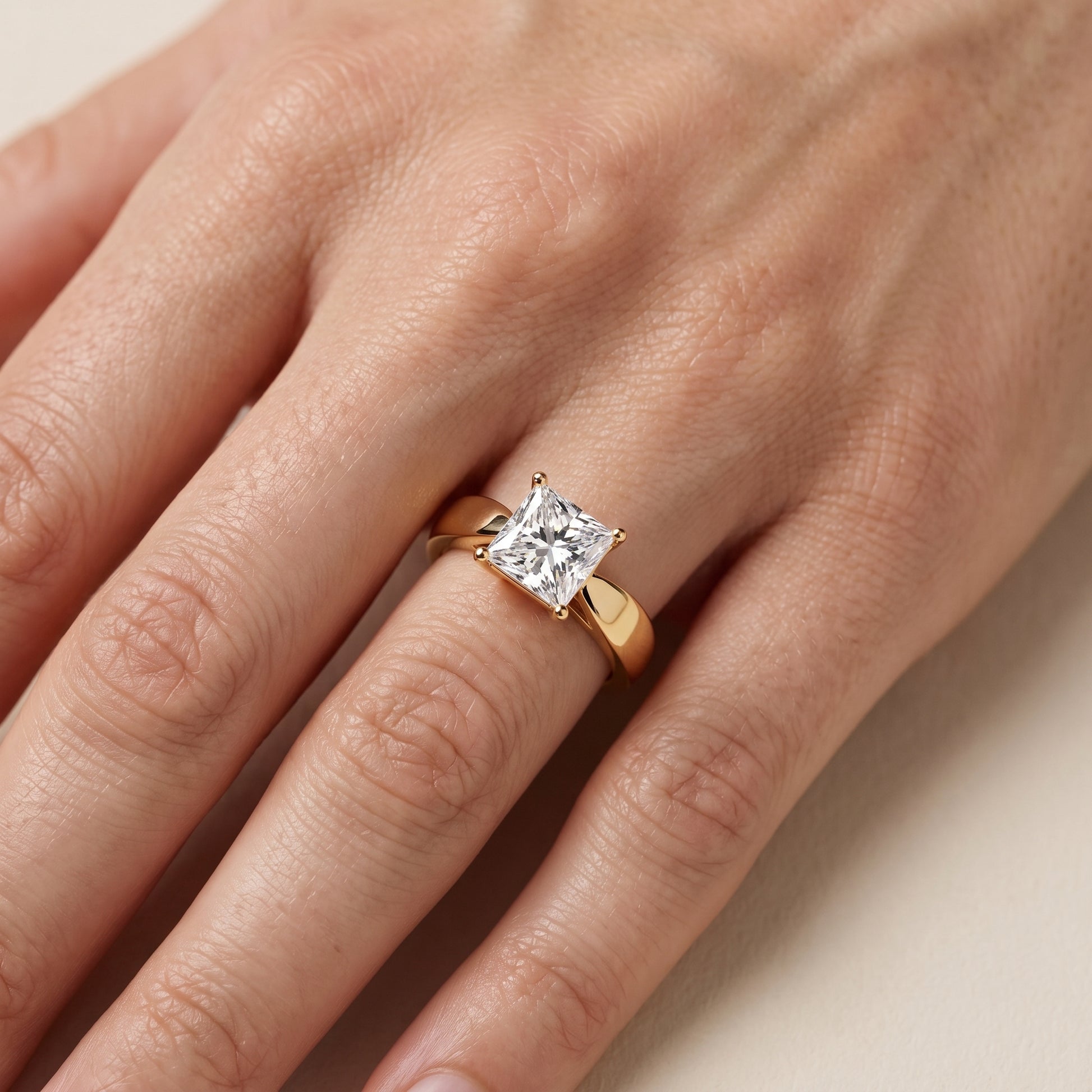Talia Solitaire Twist Princess Diamond Engagement Ring in Yellow Gold - lifestyle.jpg