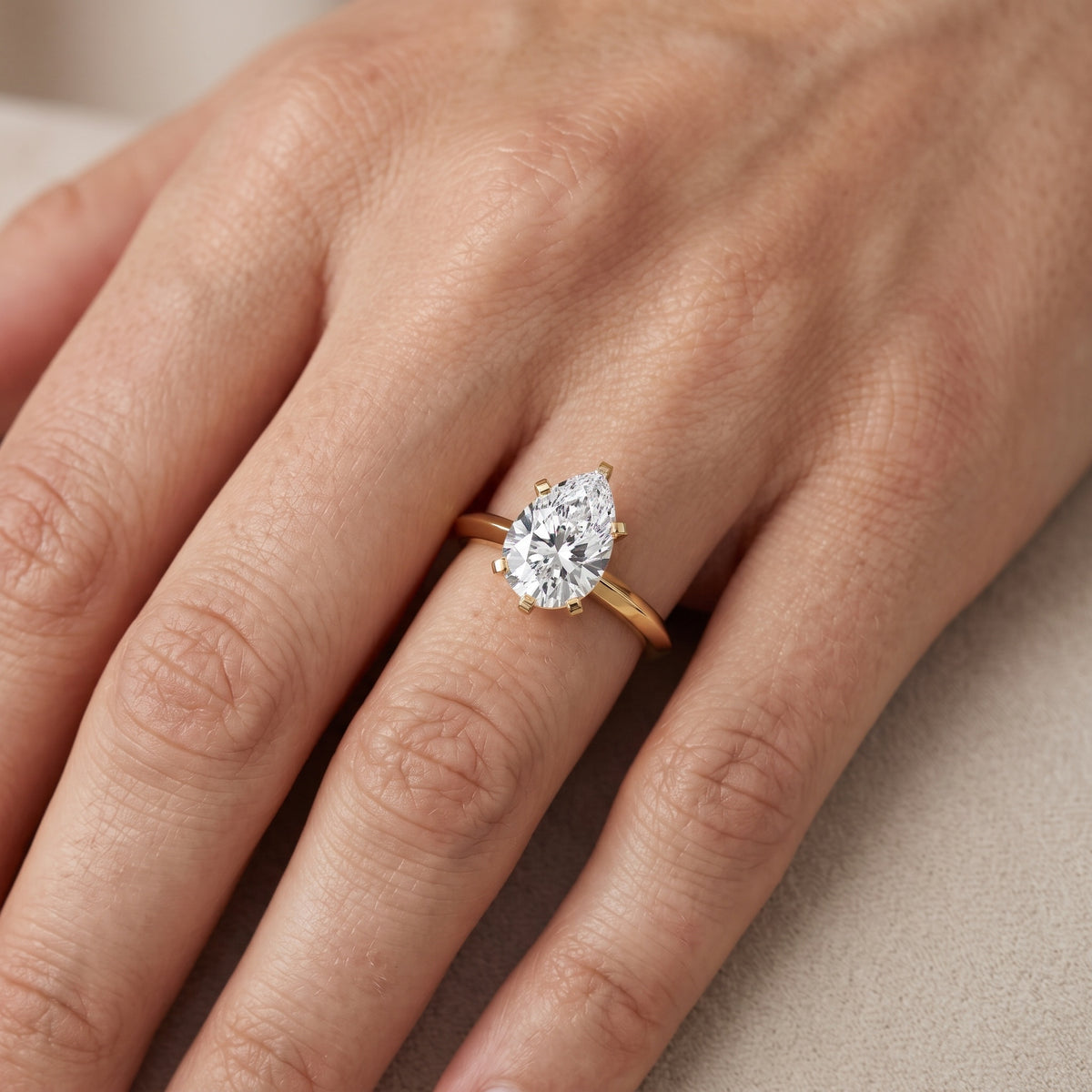 Verity Solitaire Knife Edge Pear Diamond Engagement Ring in Yellow Gold - lifestyle.jpg