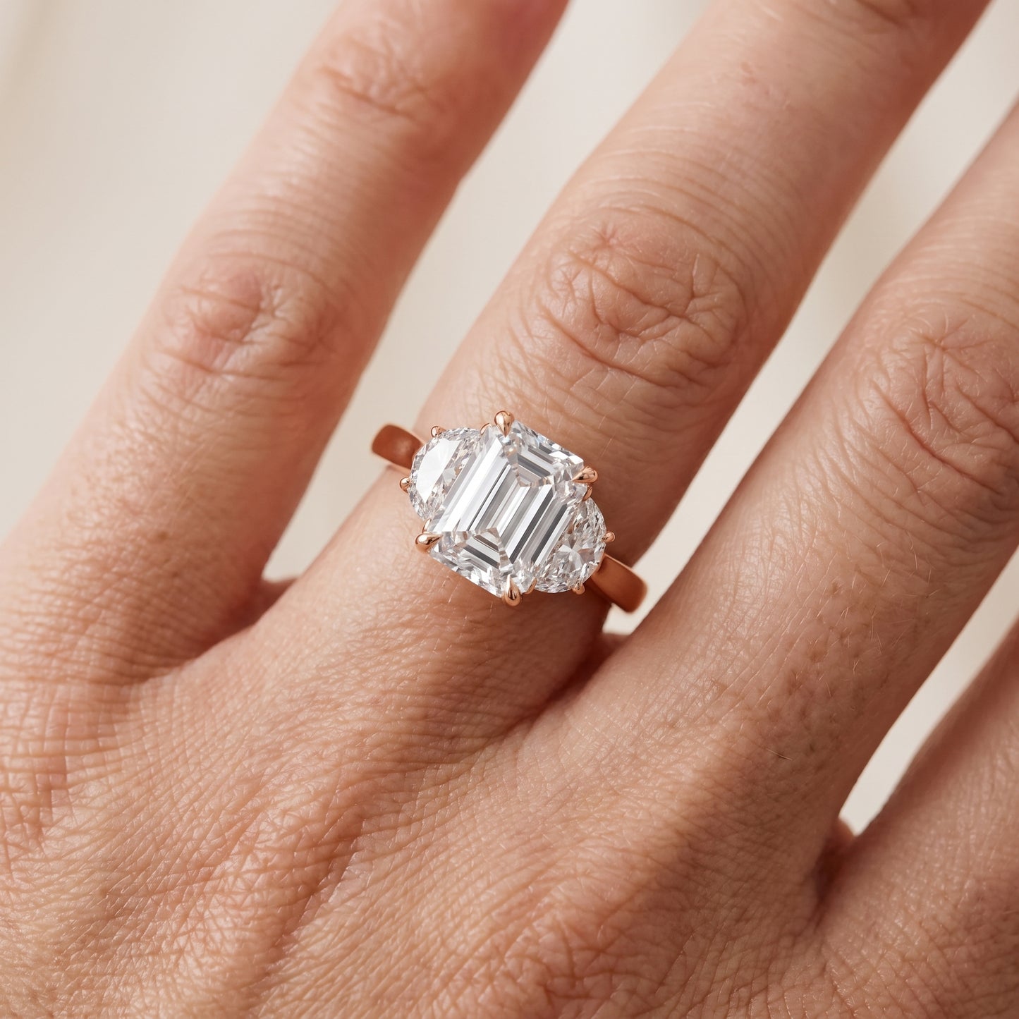 Romy Three-Stone Emerald Diamond Engagement Ring in Rose Gold - lifestyle.jpg