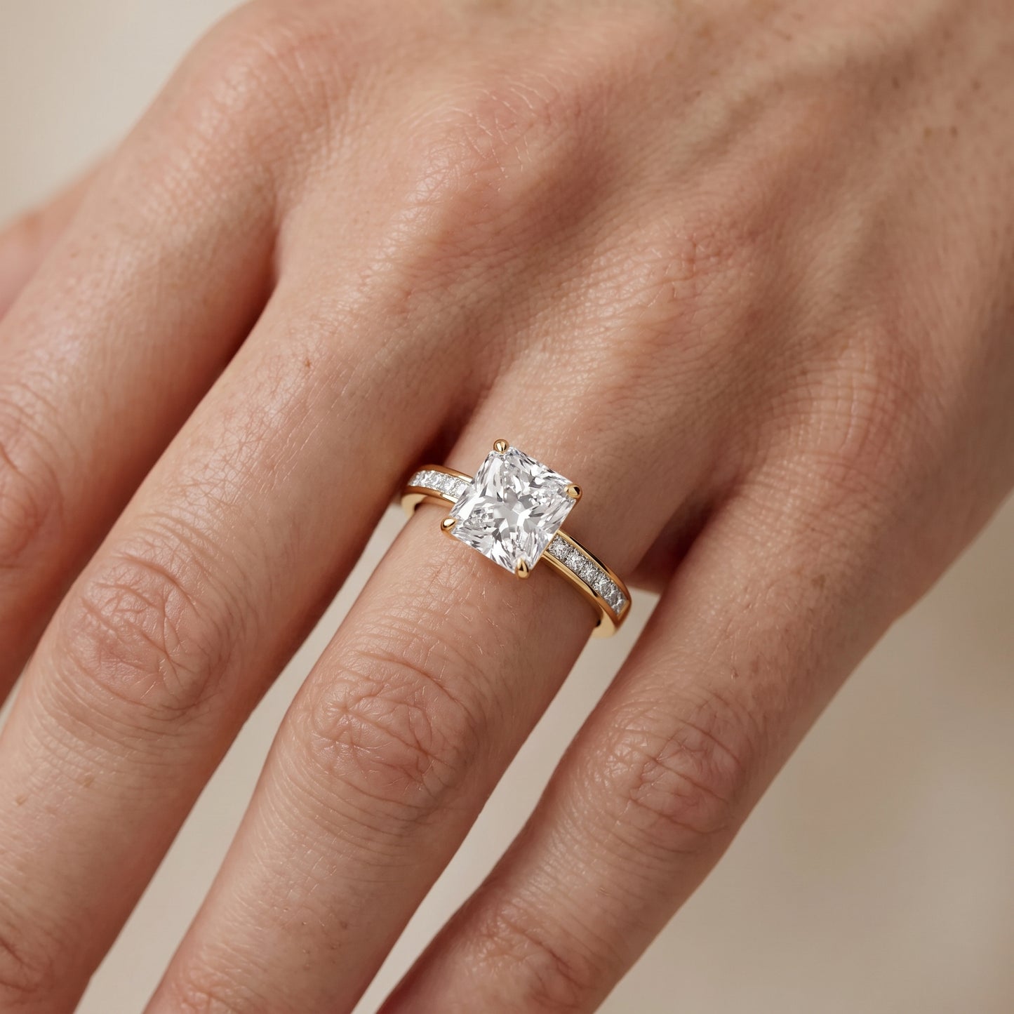 Maren Sidestone Channel Set Radiant Diamond Engagement Ring in Yellow Gold - lifestyle.jpg