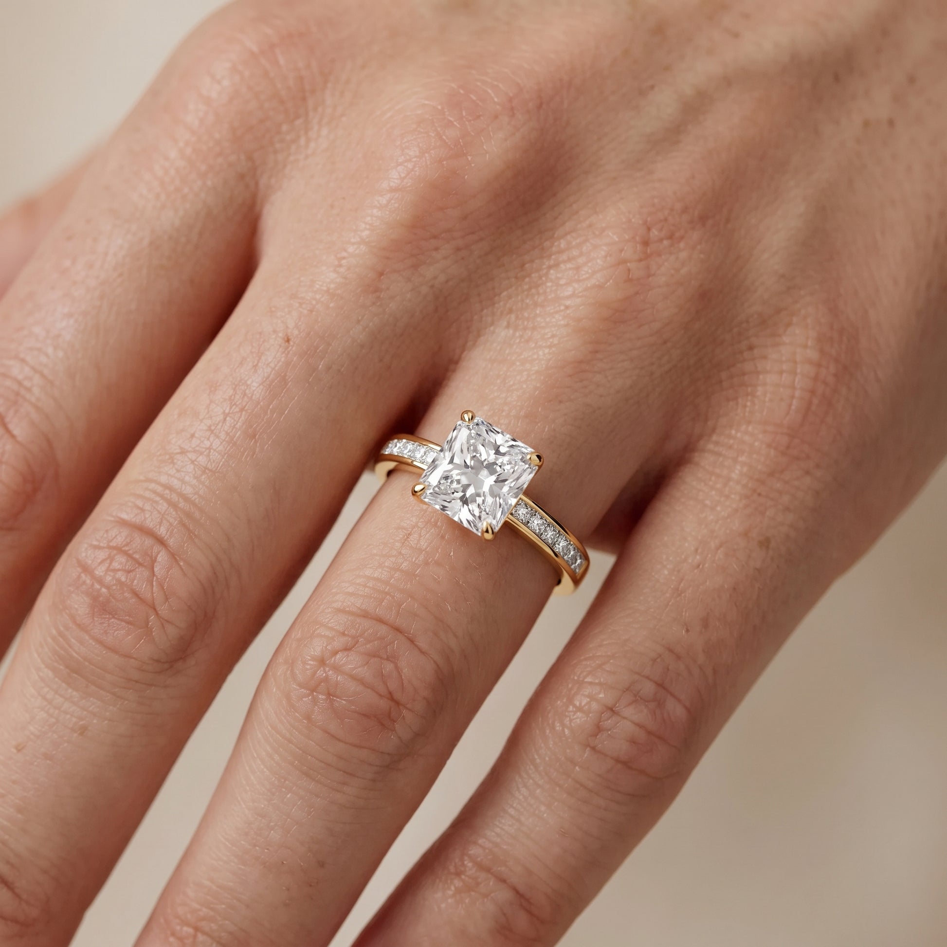 Maren Sidestone Channel Set Radiant Diamond Engagement Ring in Yellow Gold - lifestyle.jpg
