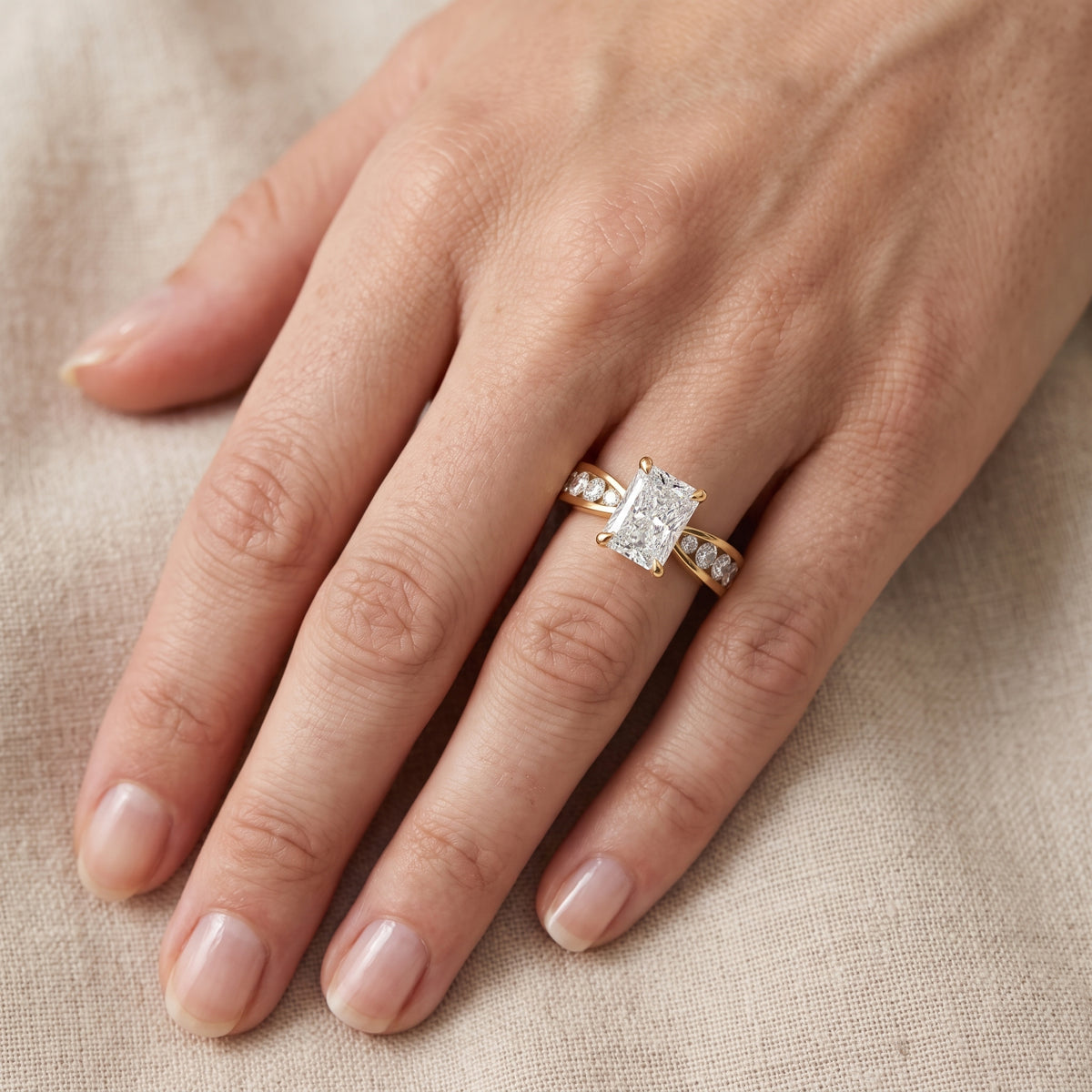 Rosalie Channel Set Sidestone Radiant Diamond Engagement Ring in Yellow Gold - lifestyle.jpg