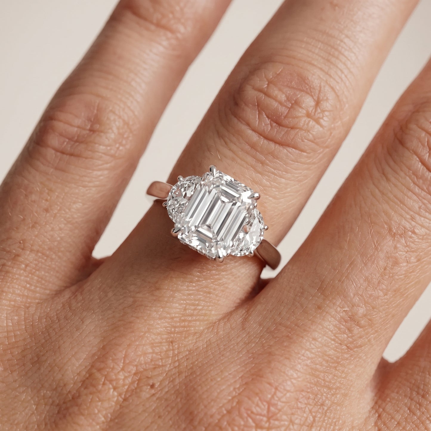 Romy Three-Stone Emerald Diamond Engagement Ring in Platinum - lifestyle.jpg