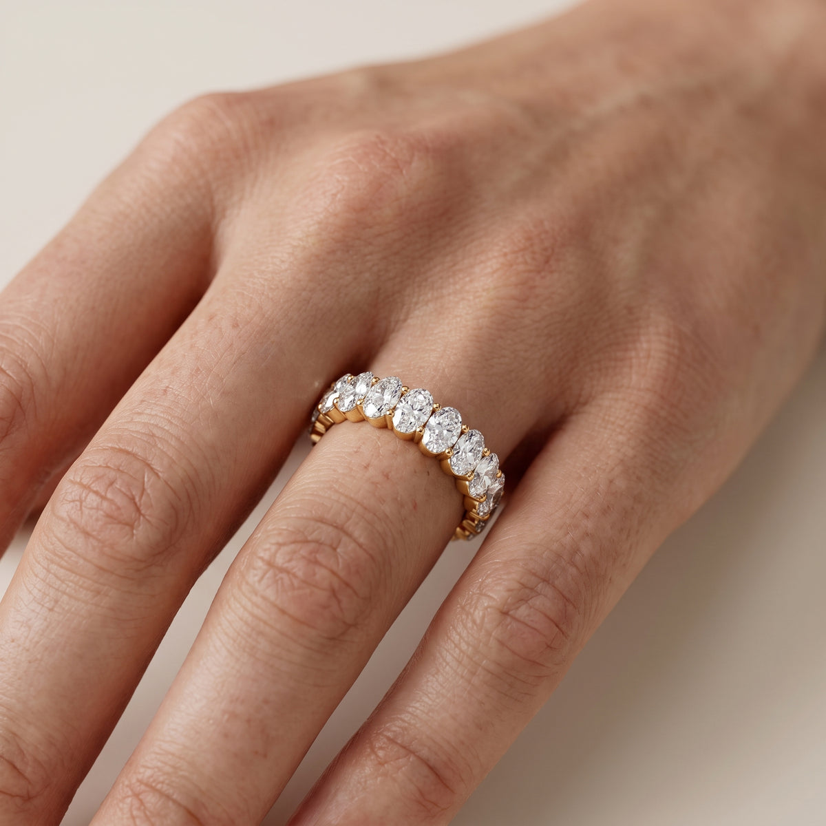 Marlowe Shared Prong Oval Diamond Eternity Band in Yellow Gold - lifestyle.jpg