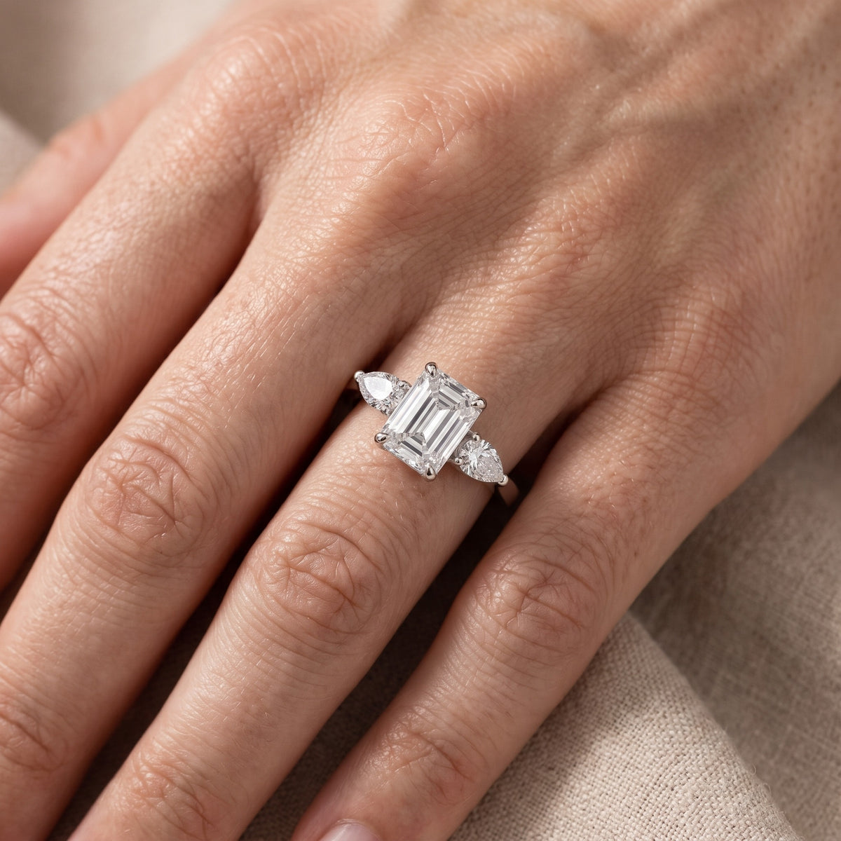 Grace Three Stone Emerald Diamond Engagement Ring in Platinum - lifestyle.jpg