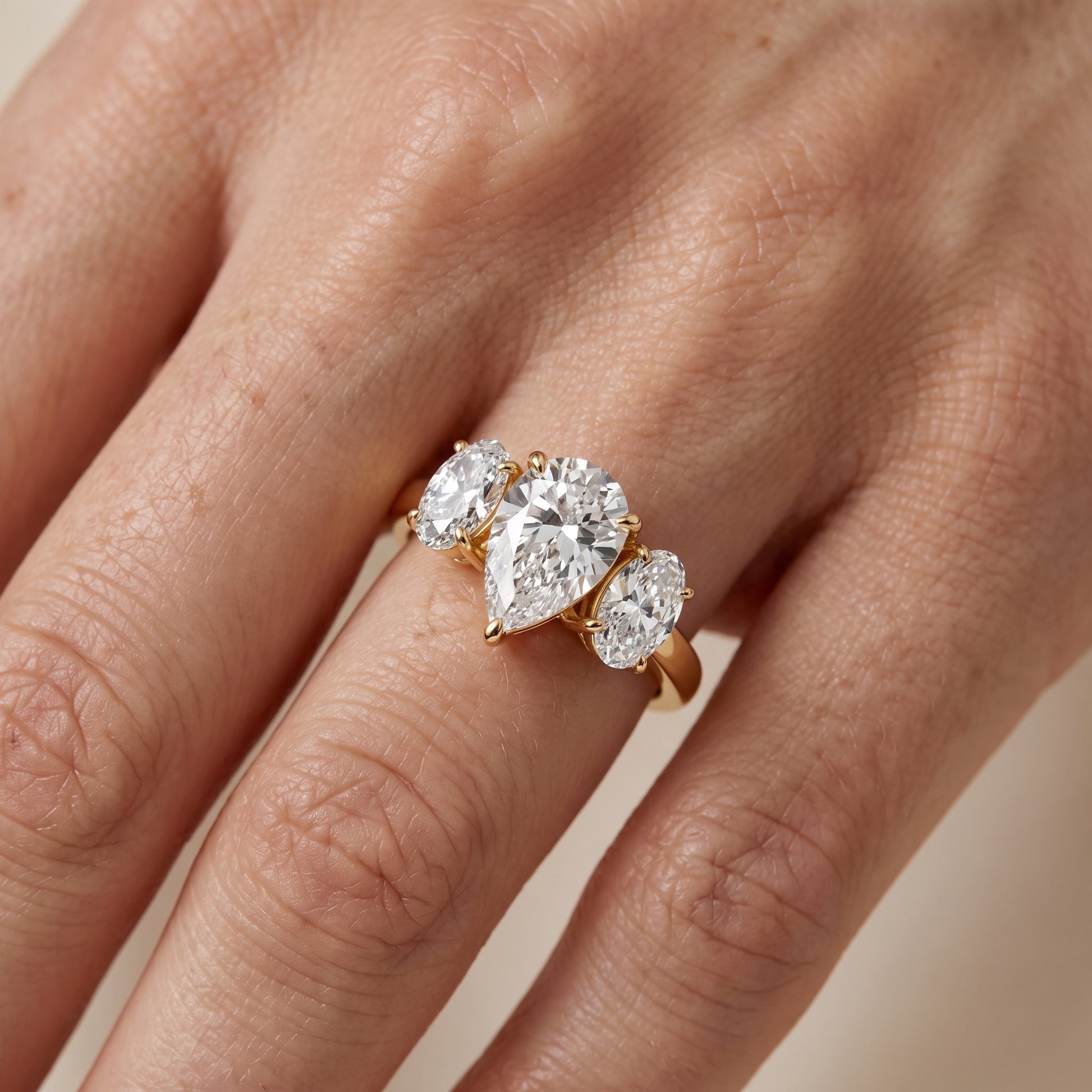 Lila Three-Stone Pear Diamond Ring in Yellow Gold - lifestyle.jpg