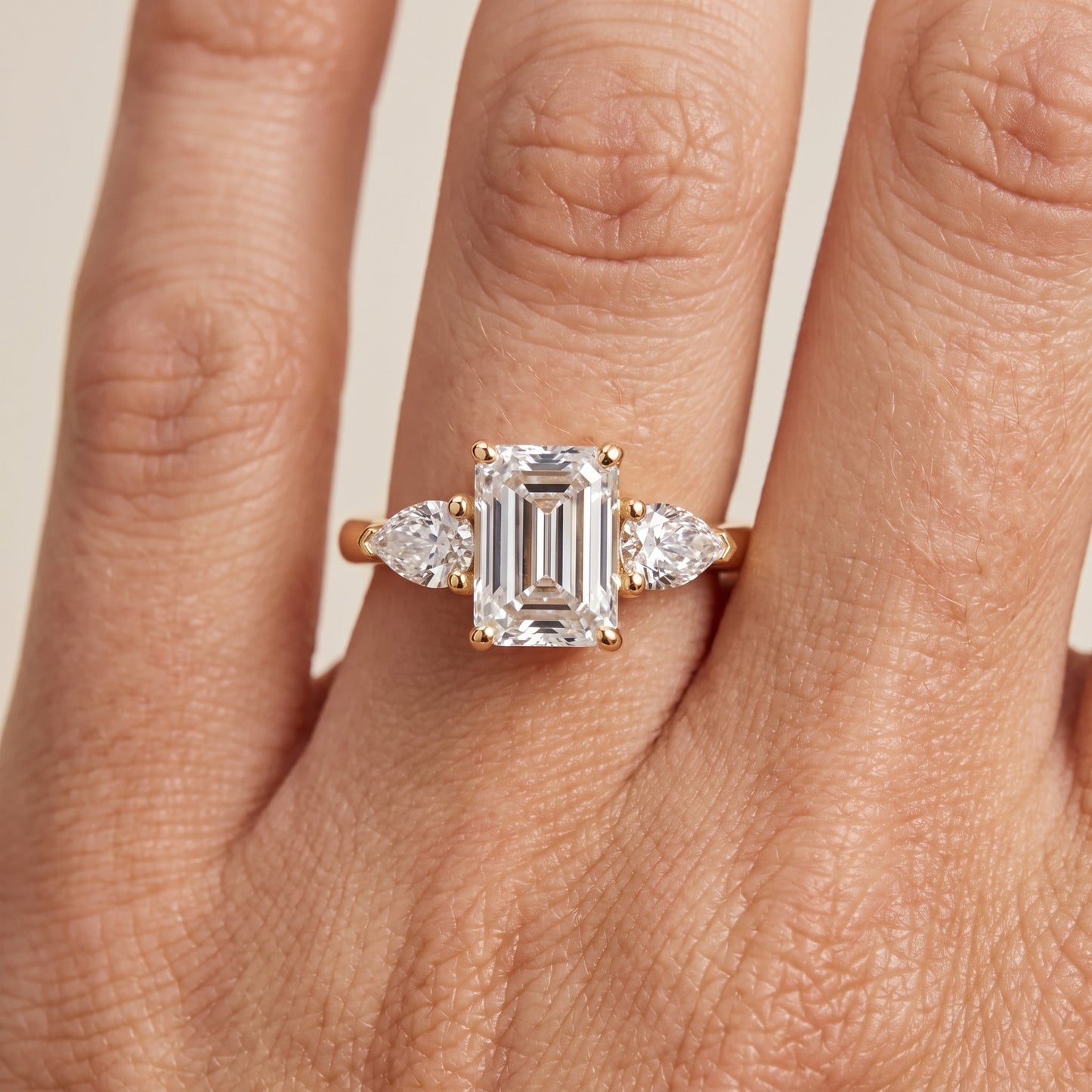 Mirabel Three-Stone Emerald Diamond Engagement Ring in Yellow Gold - lifestyle.jpg