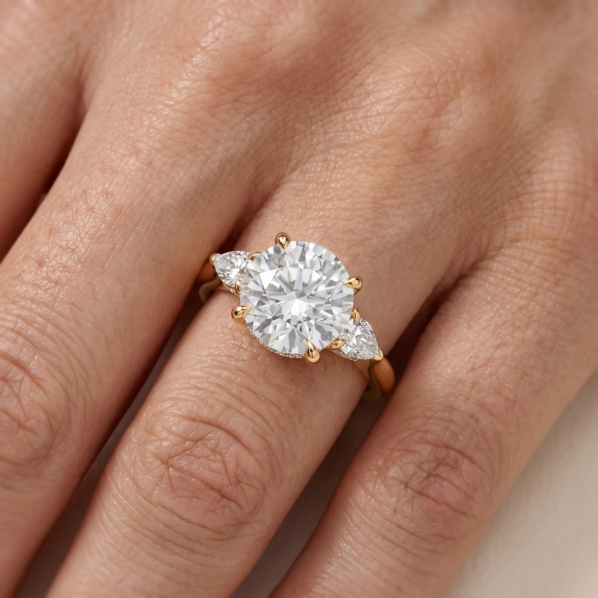Leila Three-Stone Round Diamond Engagement Ring in Yellow Gold - lifestyle.jpg