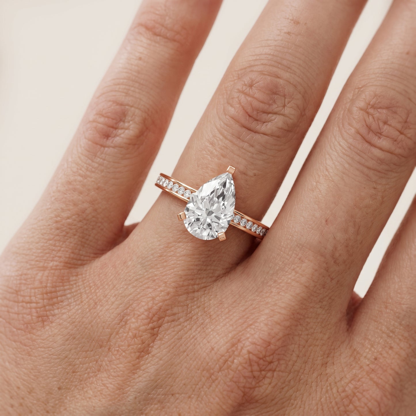 Tessa Solitaire Channel Set Pear Diamond Engagement Ring in Rose Gold - lifestyle.jpg