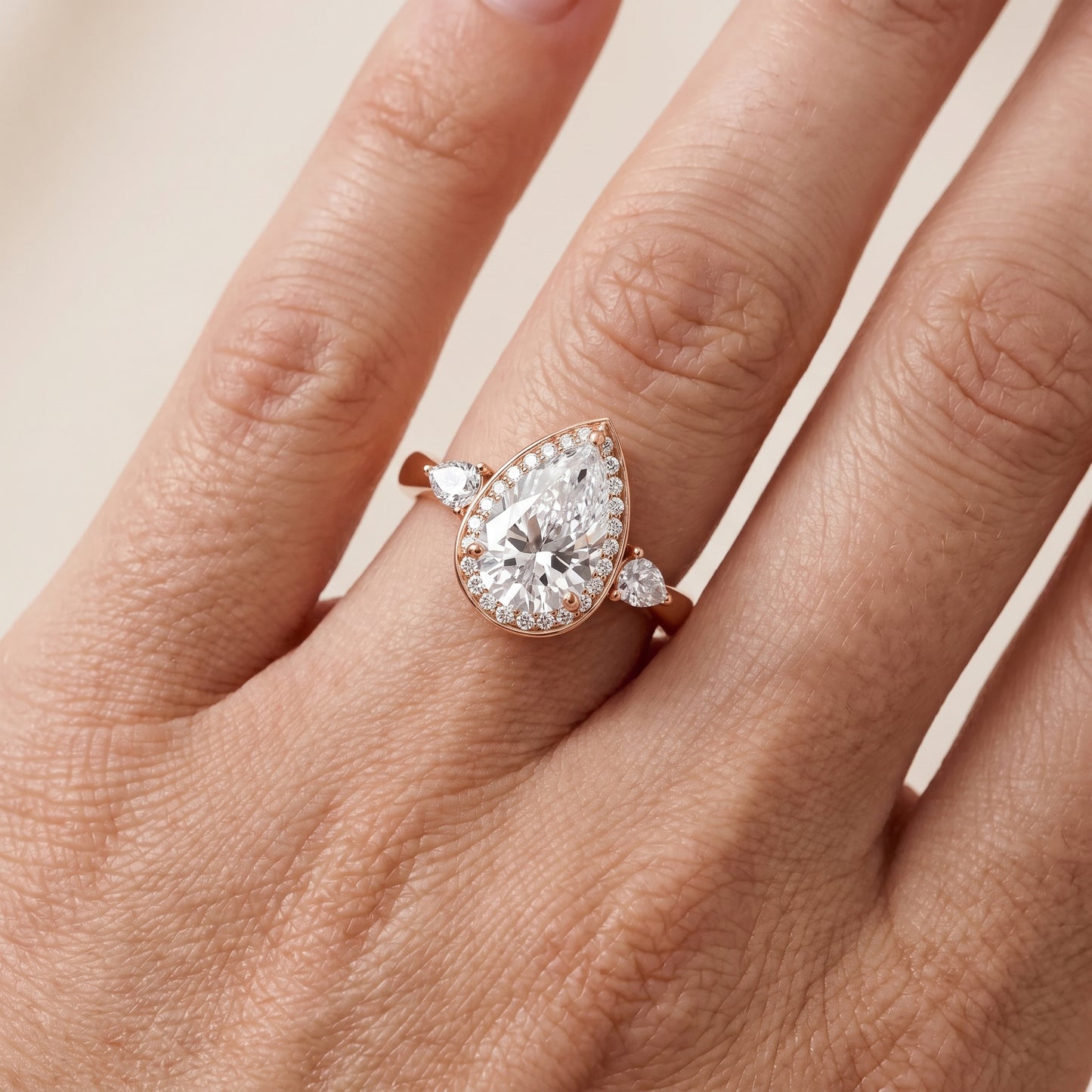 Eliza Halo Sidestone Pear Diamond Engagement Ring in Rose Gold - lifestyle.jpg