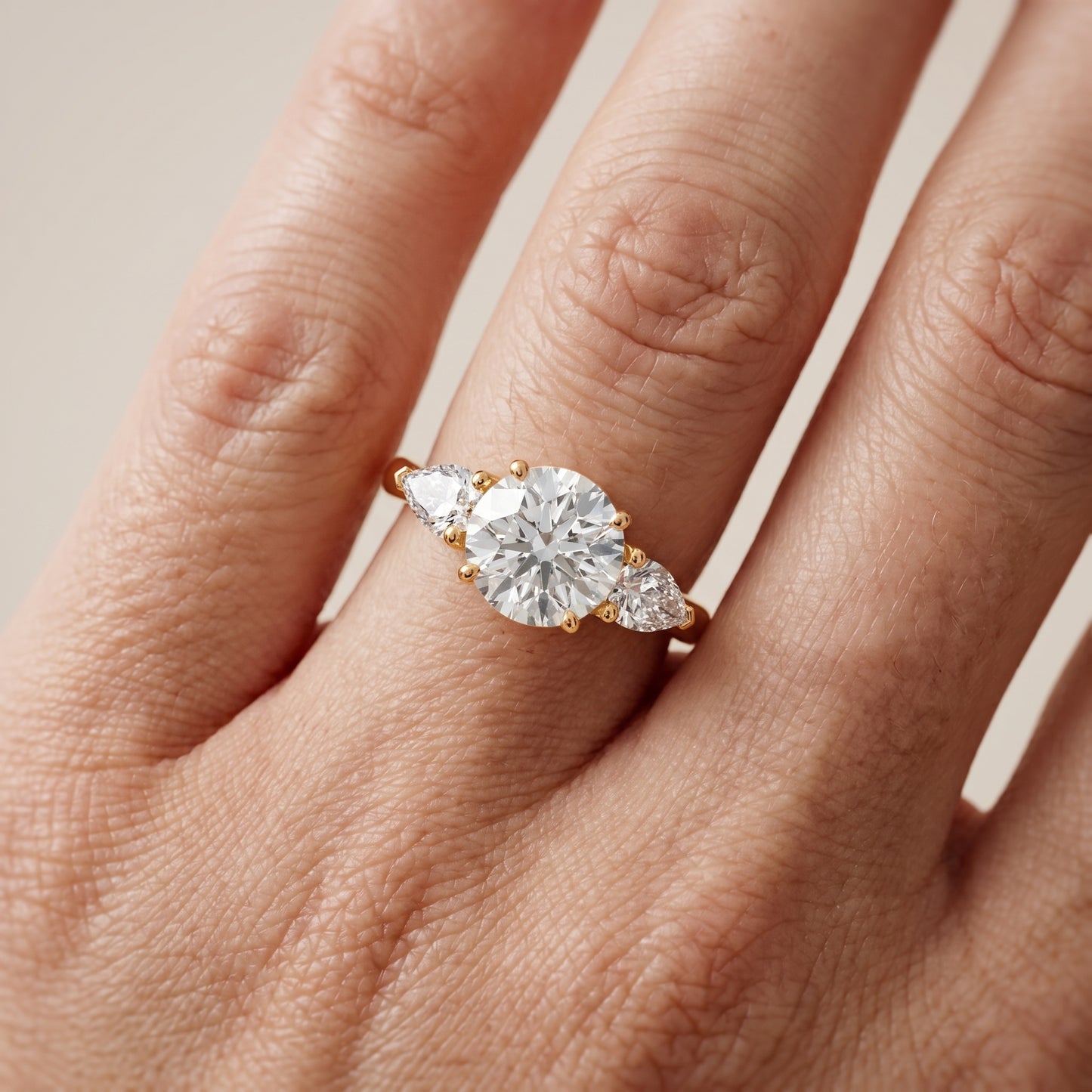 Mirabel Three-Stone Round Diamond Engagement Ring in Yellow Gold - lifestyle.jpg