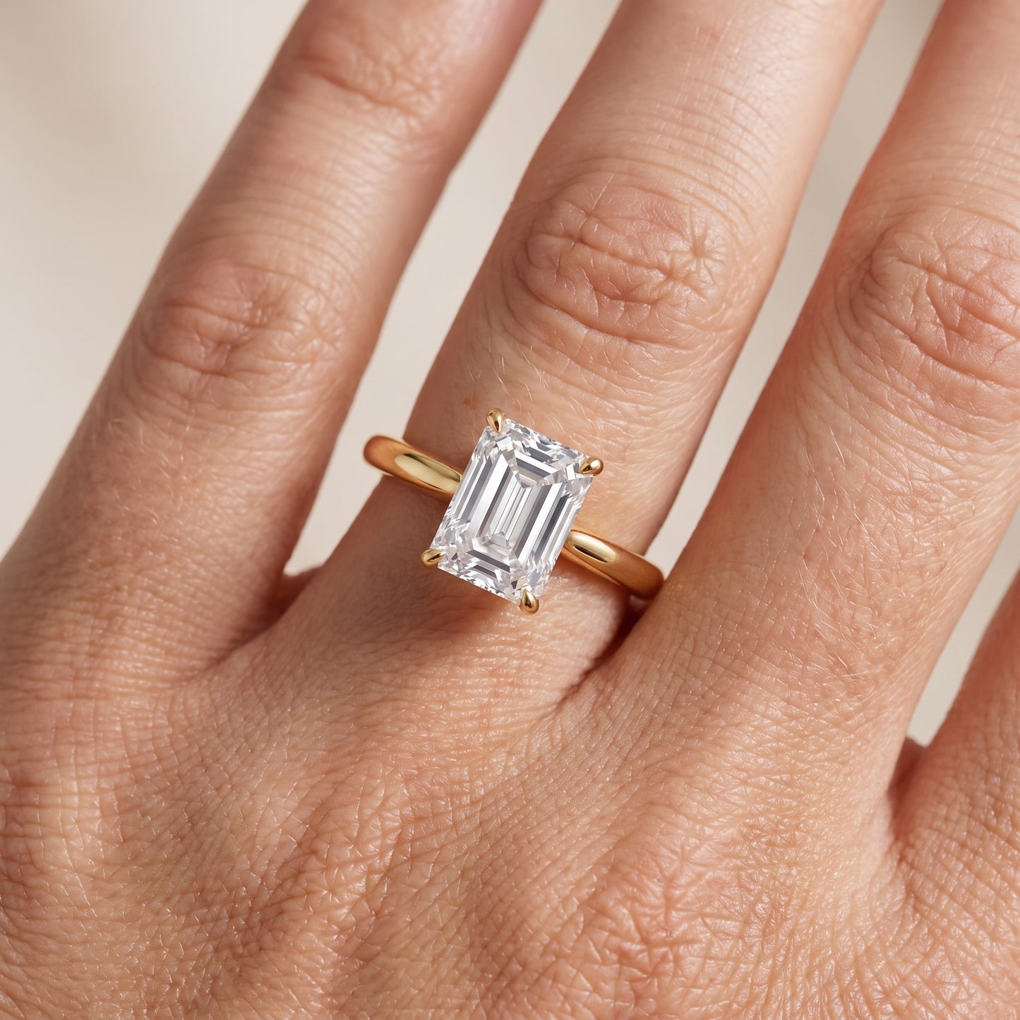 Kalia Knife Edge Solitaire Emerald Diamond Engagement Ring in Yellow Gold - lifestyle.jpg