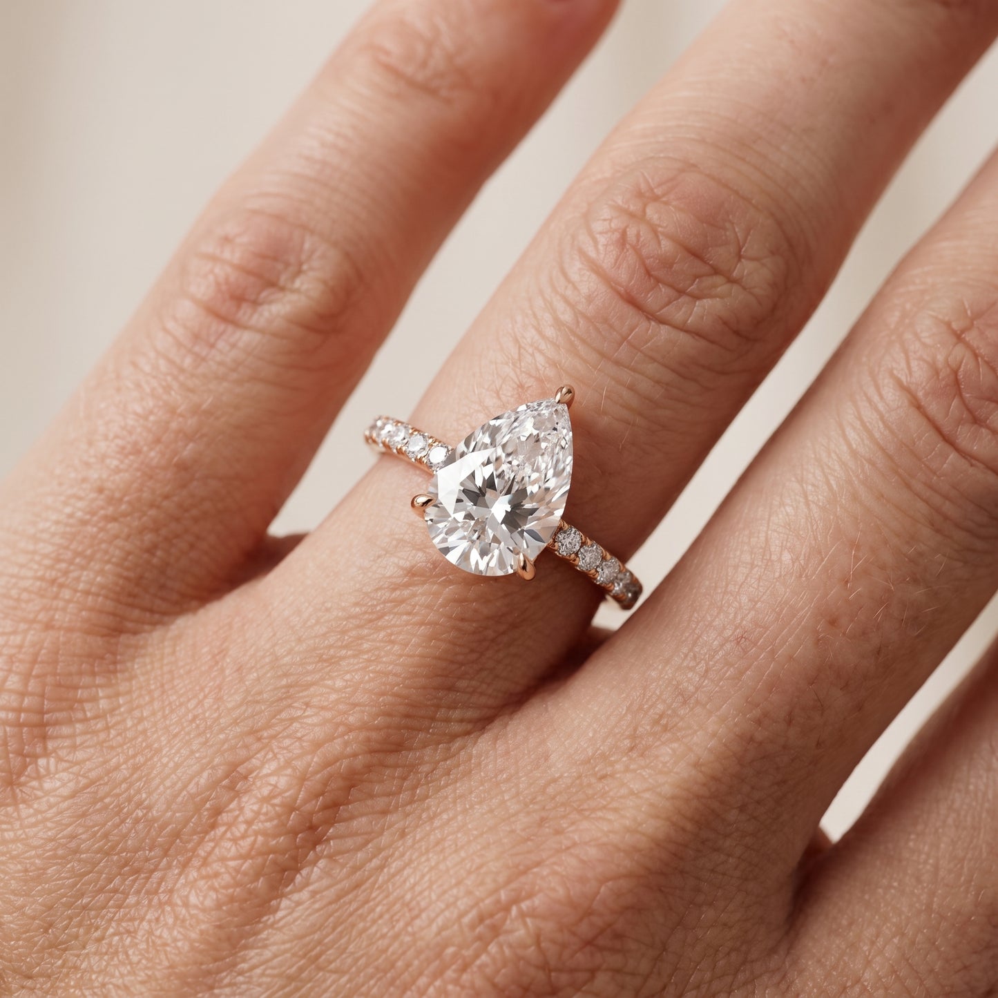 Ione Solitaire Pavé Pear Diamond Engagement Ring in Rose Gold - lifestyle.jpg