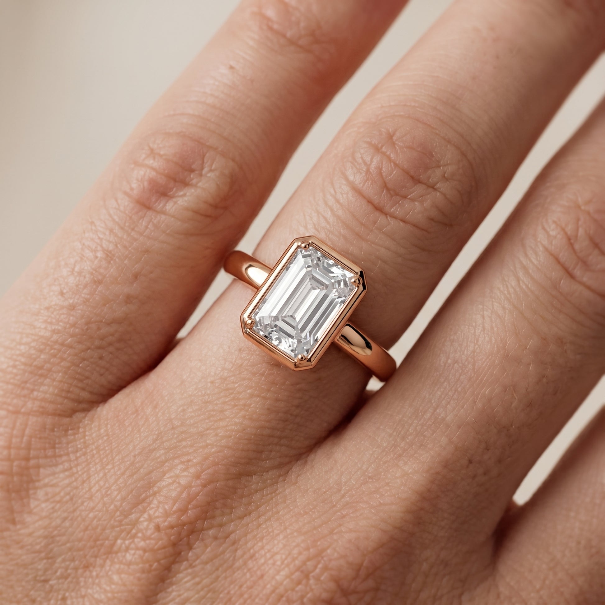 Alina Bezel Solitaire Emerald Diamond Ring in Rose Gold - lifestyle.jpg