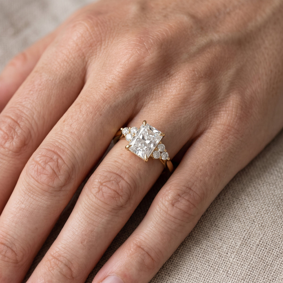 Anya Sidestone Cluster Radiant Diamond Engagement Ring in Yellow Gold - lifestyle.jpg