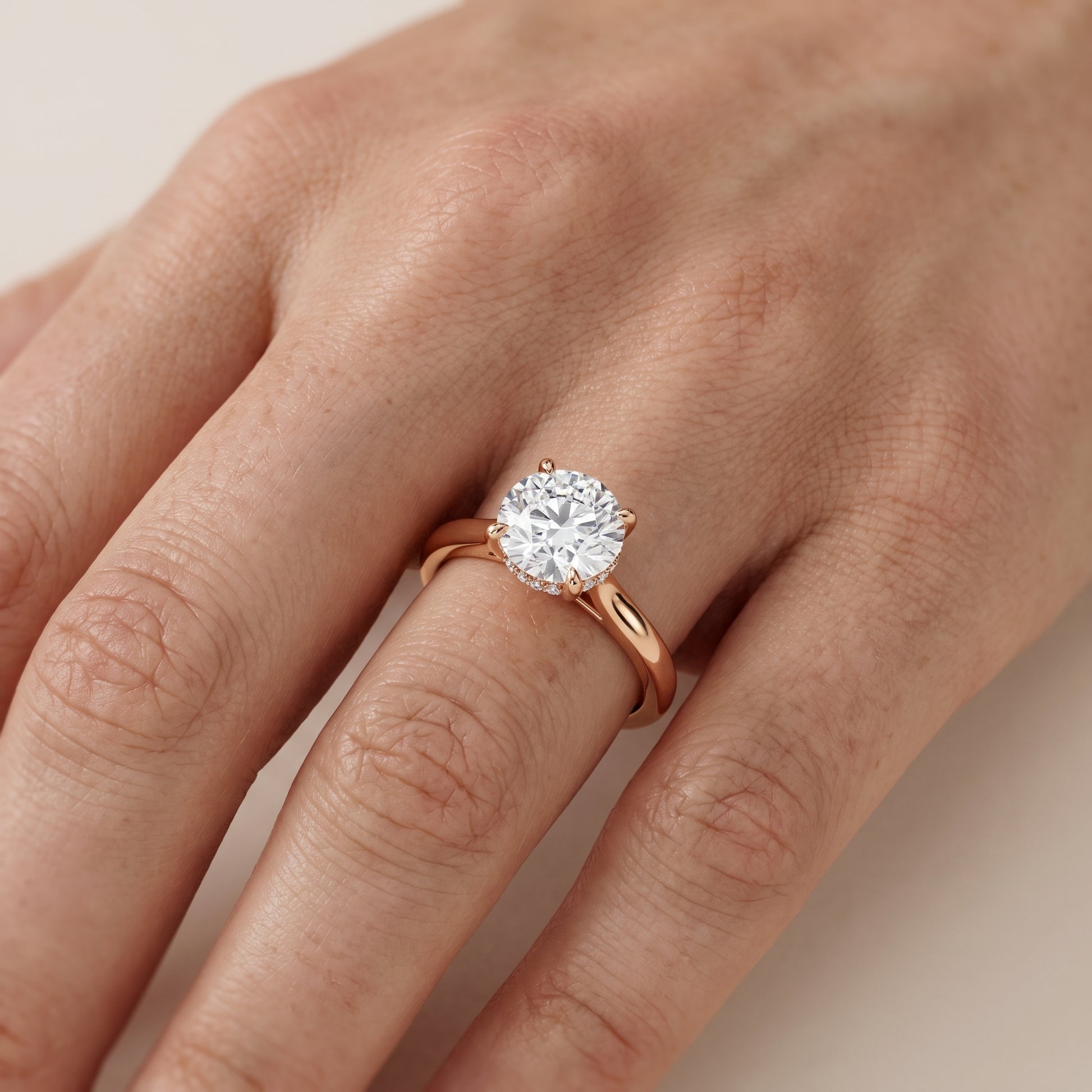 Mena Hidden Halo Round Diamond Engagement Ring in Rose Gold - lifestyle.jpg