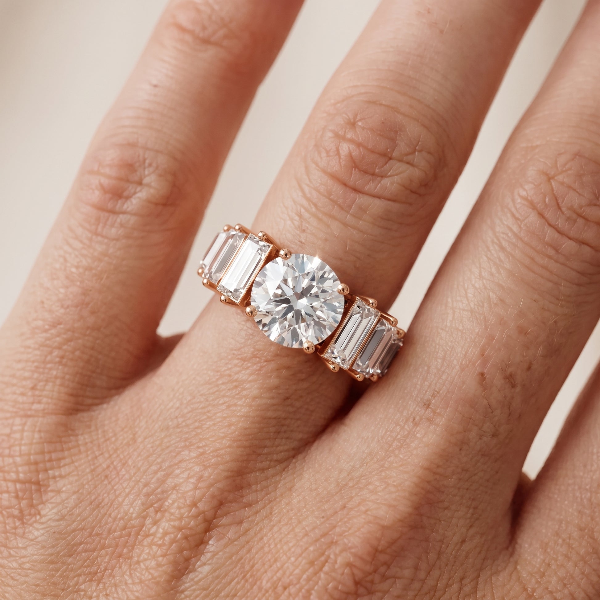 Mara Sidestone Baguette Accent Round Diamond Engagement Ring in Rose Gold - lifestyle.jpg