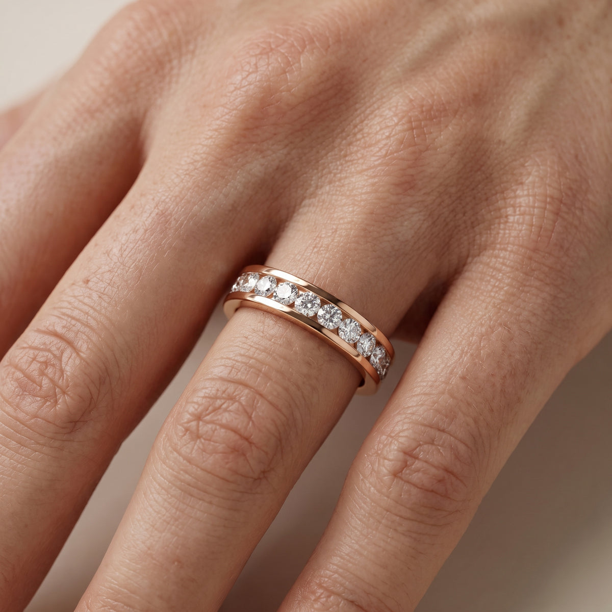 Catherine Channel Set Round Diamond Eternity Band in Rose Gold - lifestyle.jpg