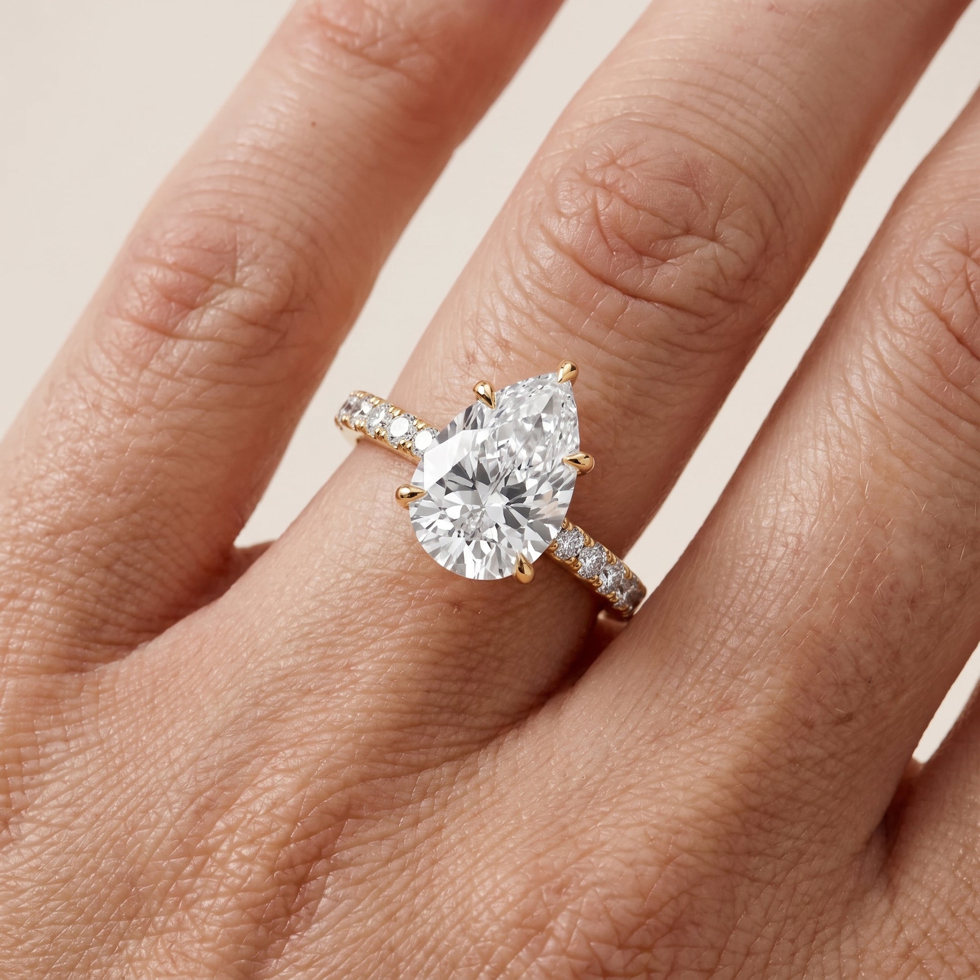 Gia Hidden Halo Pavé Pear Diamond Ring in Yellow Gold - lifestyle.jpg