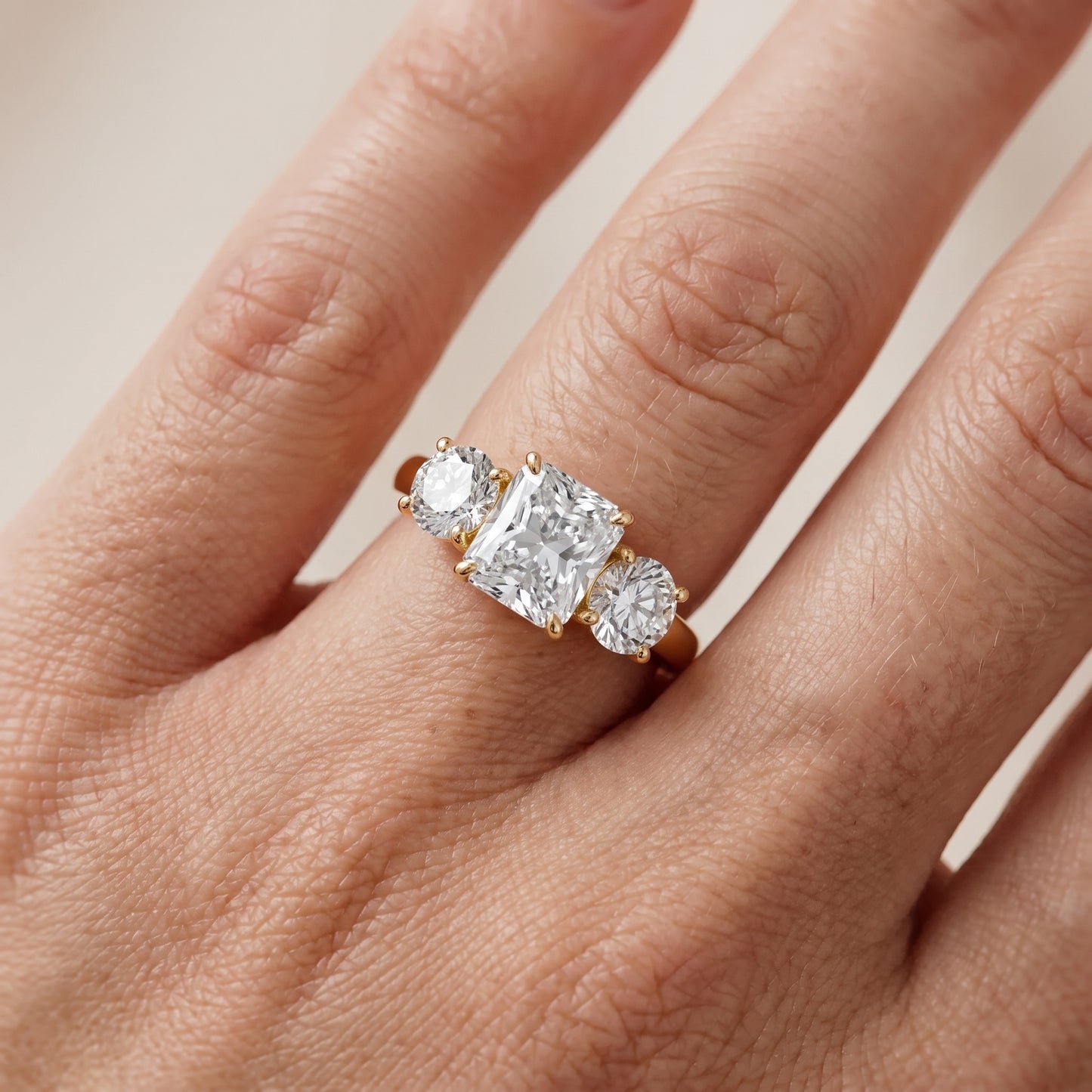 Esme Three-Stone Tapered Radiant Diamond Ring in Yellow Gold - lifestyle.jpg