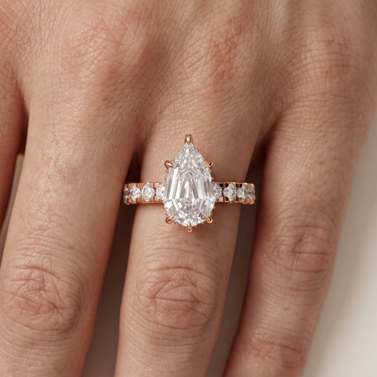 Delaney Hidden Halo French Pavé Step Cut Pear Diamond Engagement Ring in Rose Gold - lifestyle.jpg