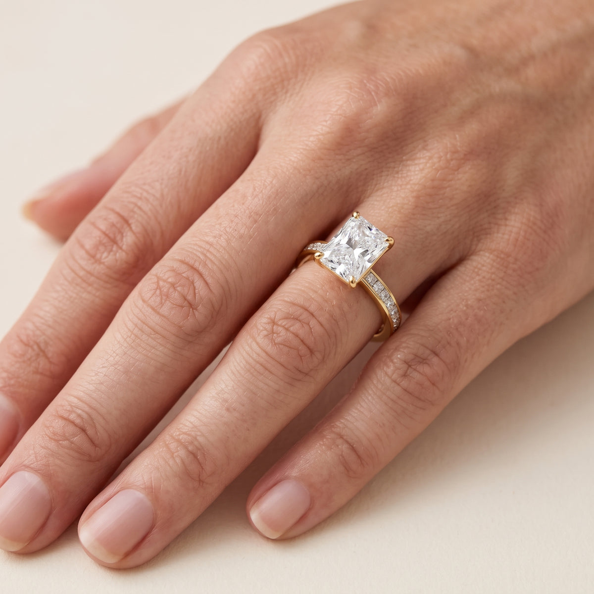 Brielle Channel Set Solitaire Radiant Diamond Engagement Ring in Yellow Gold - lifestyle.jpg