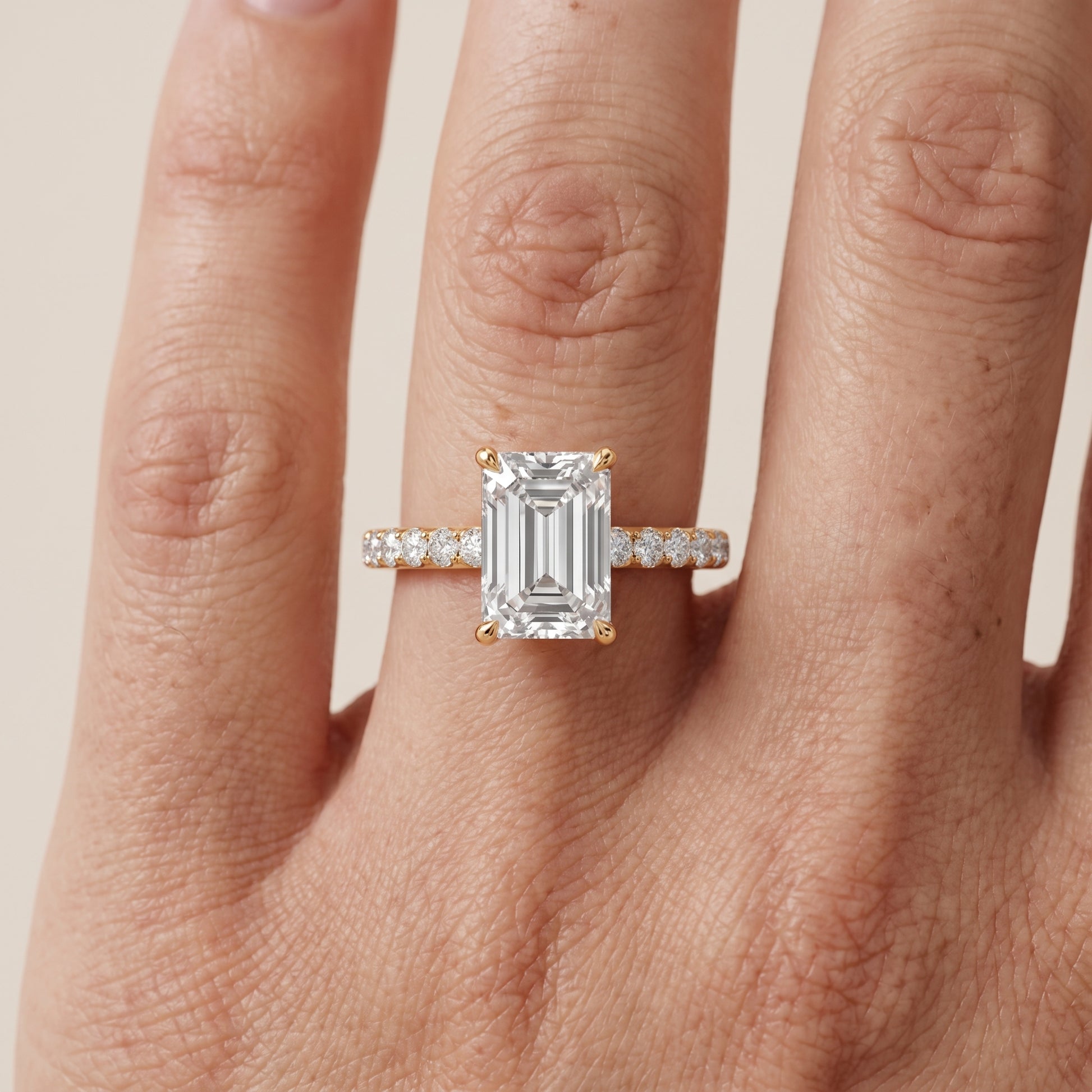 Thea Hidden Halo Pavé Emerald Diamond Engagement Ring in Yellow Gold - lifestyle.jpg