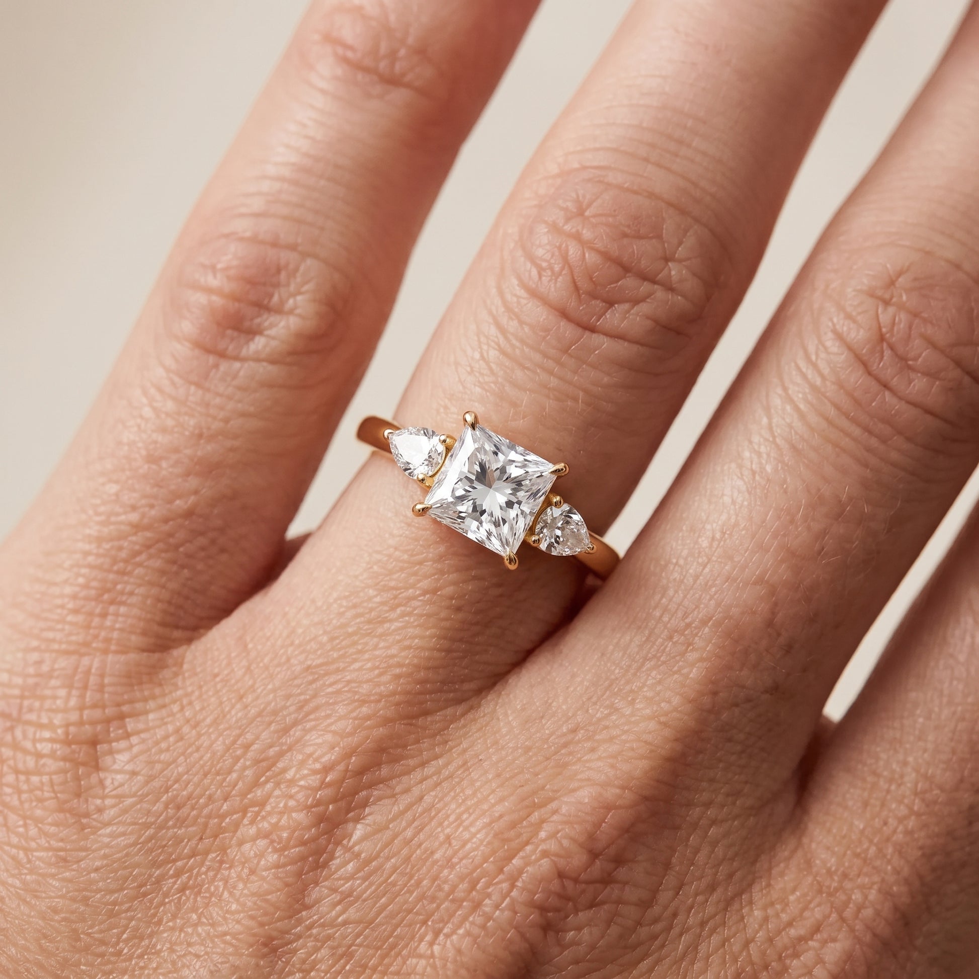 Phoebe Three-Stone Princess Diamond Ring in Yellow Gold - lifestyle.jpg