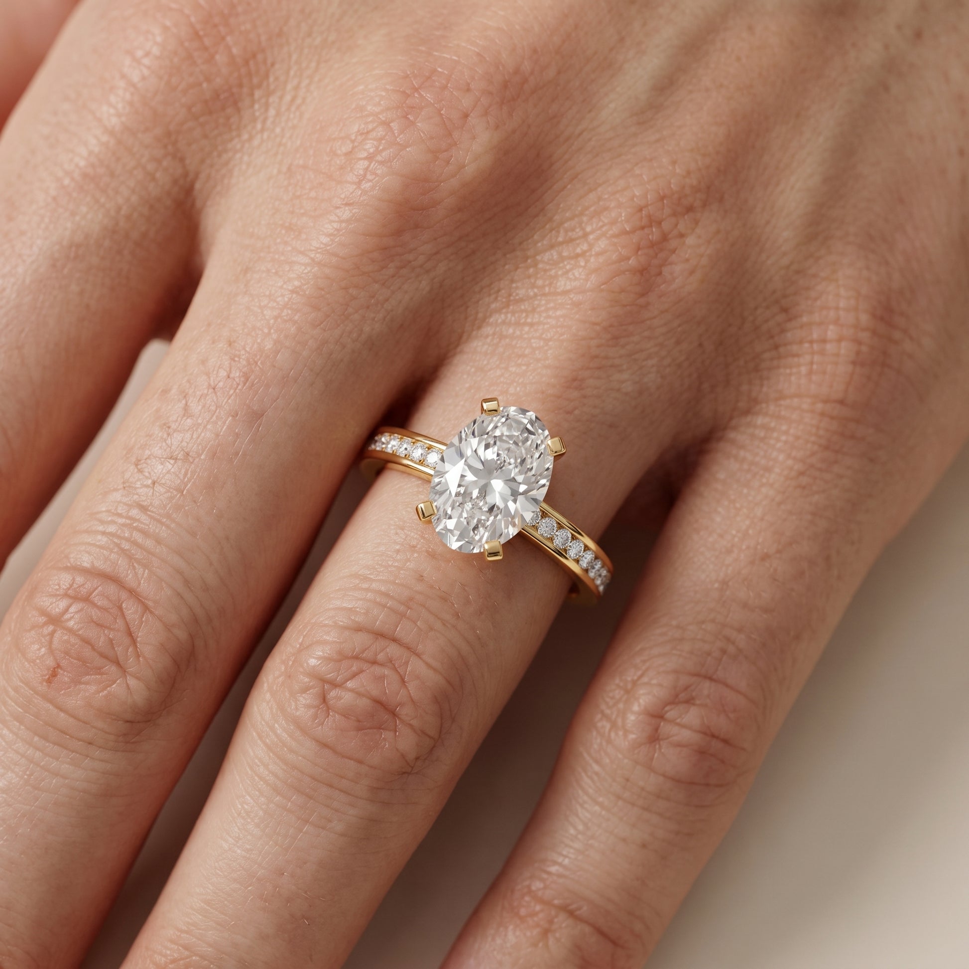 Tessa Solitaire Channel Set Oval Diamond Engagement Ring in Yellow Gold - lifestyle.jpg